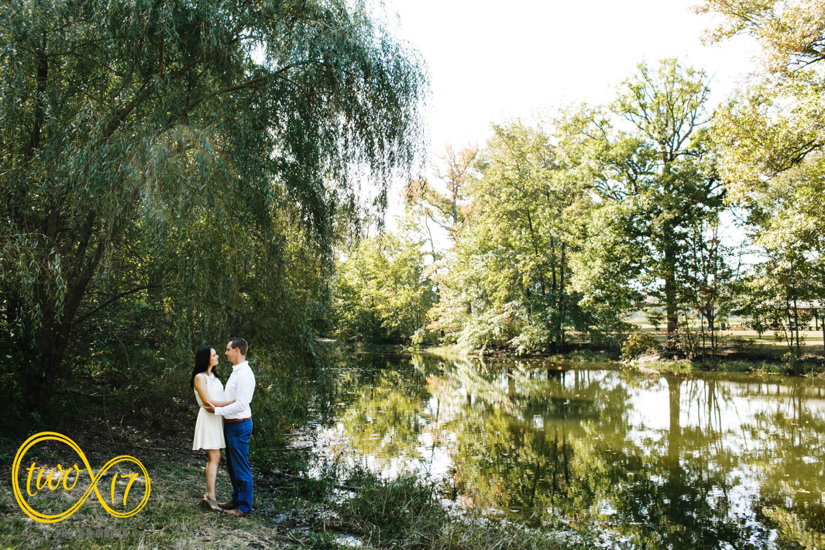 Portrait of a couple by a lake during their fall engagement photoshoot at Bellevue State Park. 