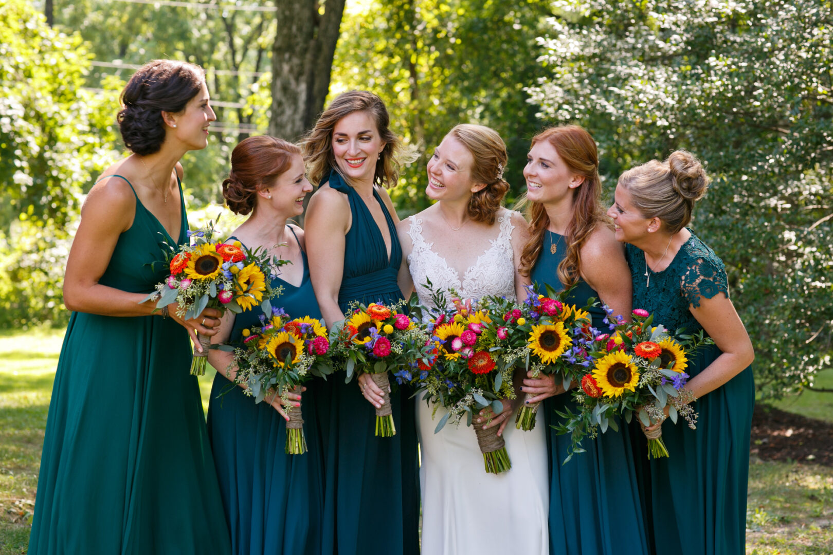bride with her bridesmaids in teal aqua bridesmaid dresses at a summer outdoor Pennsylvania wedding. 