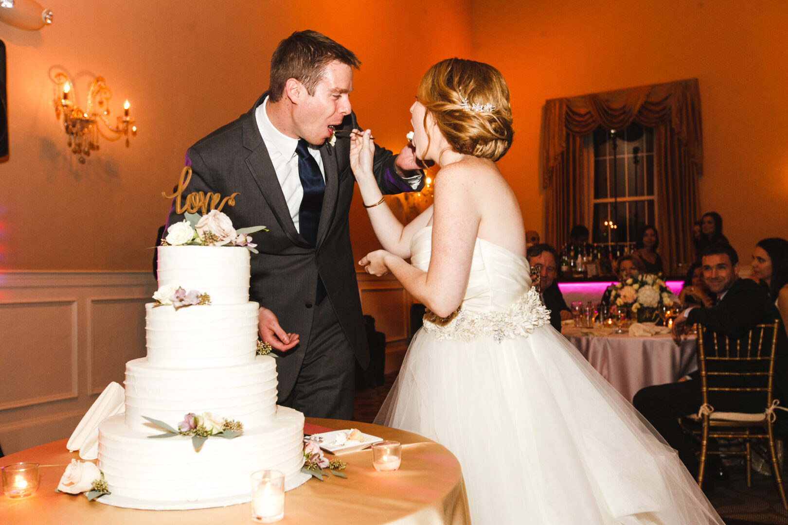 A bride and groom cut their wedding cake during the reception in Phoenixville at The Columbia Station wedding venue.