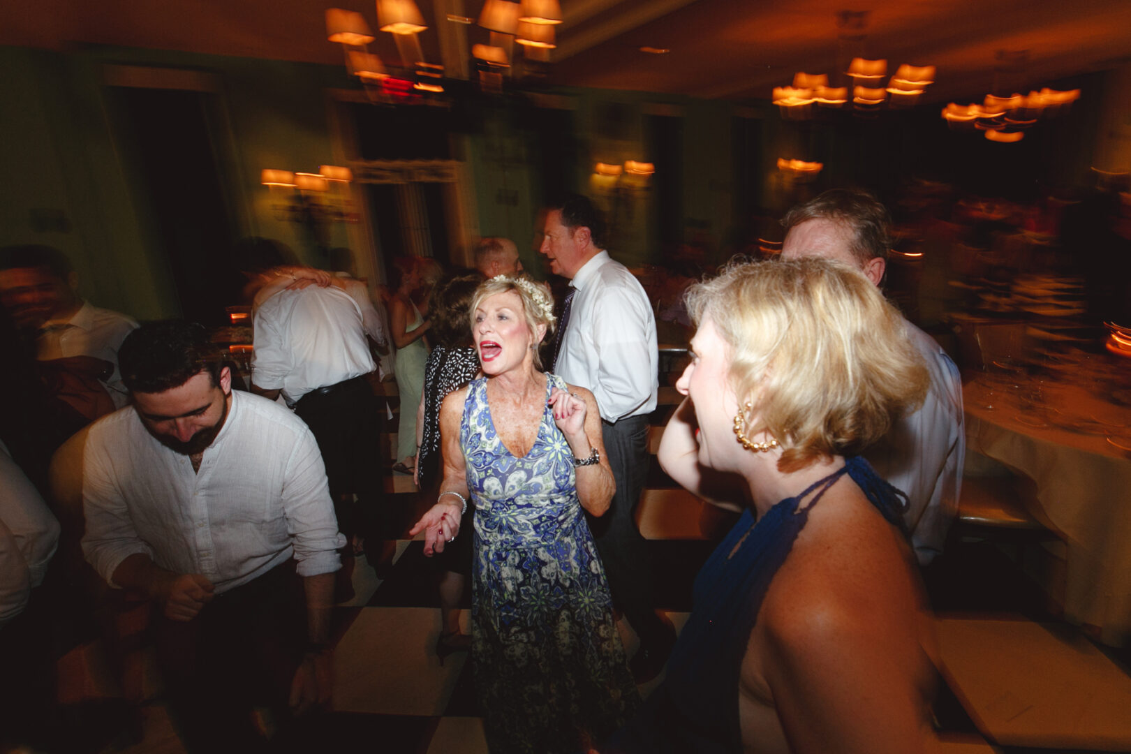Guests danced energetically on the checkered floor of Congress Hall, the dimly lit room glowing softly under elegant chandeliers.