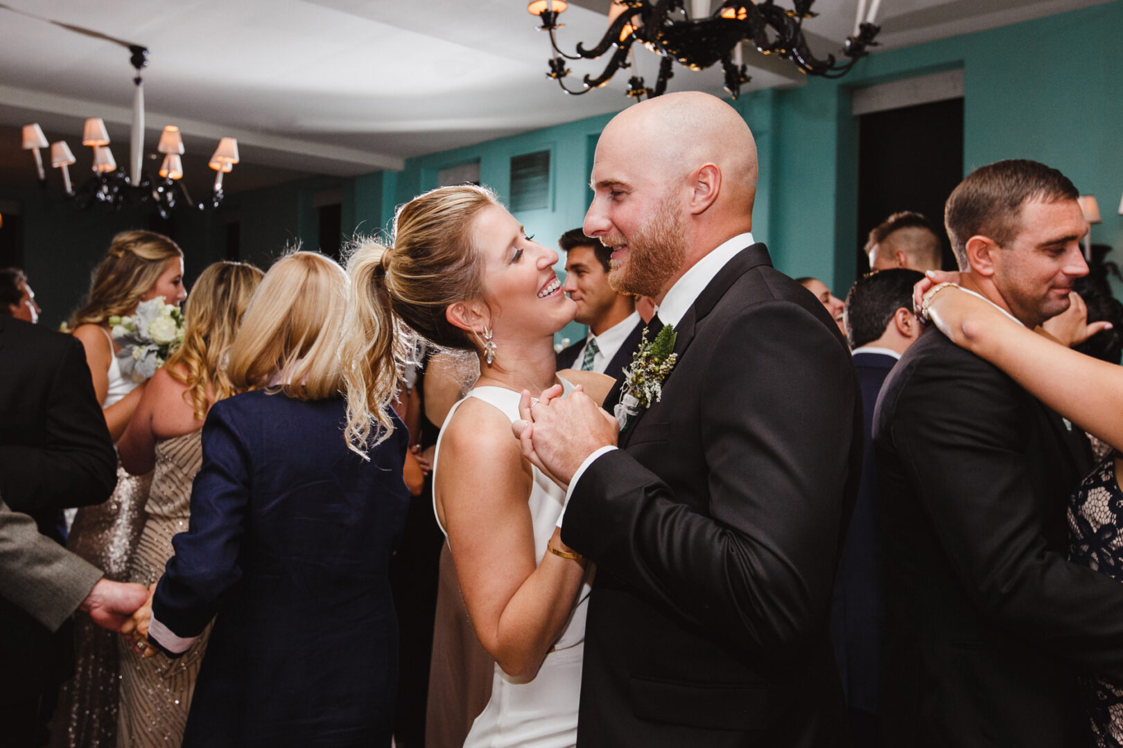At a picturesque Congress Hall wedding, a couple dances closely amidst elegantly dressed guests, creating unforgettable memories.