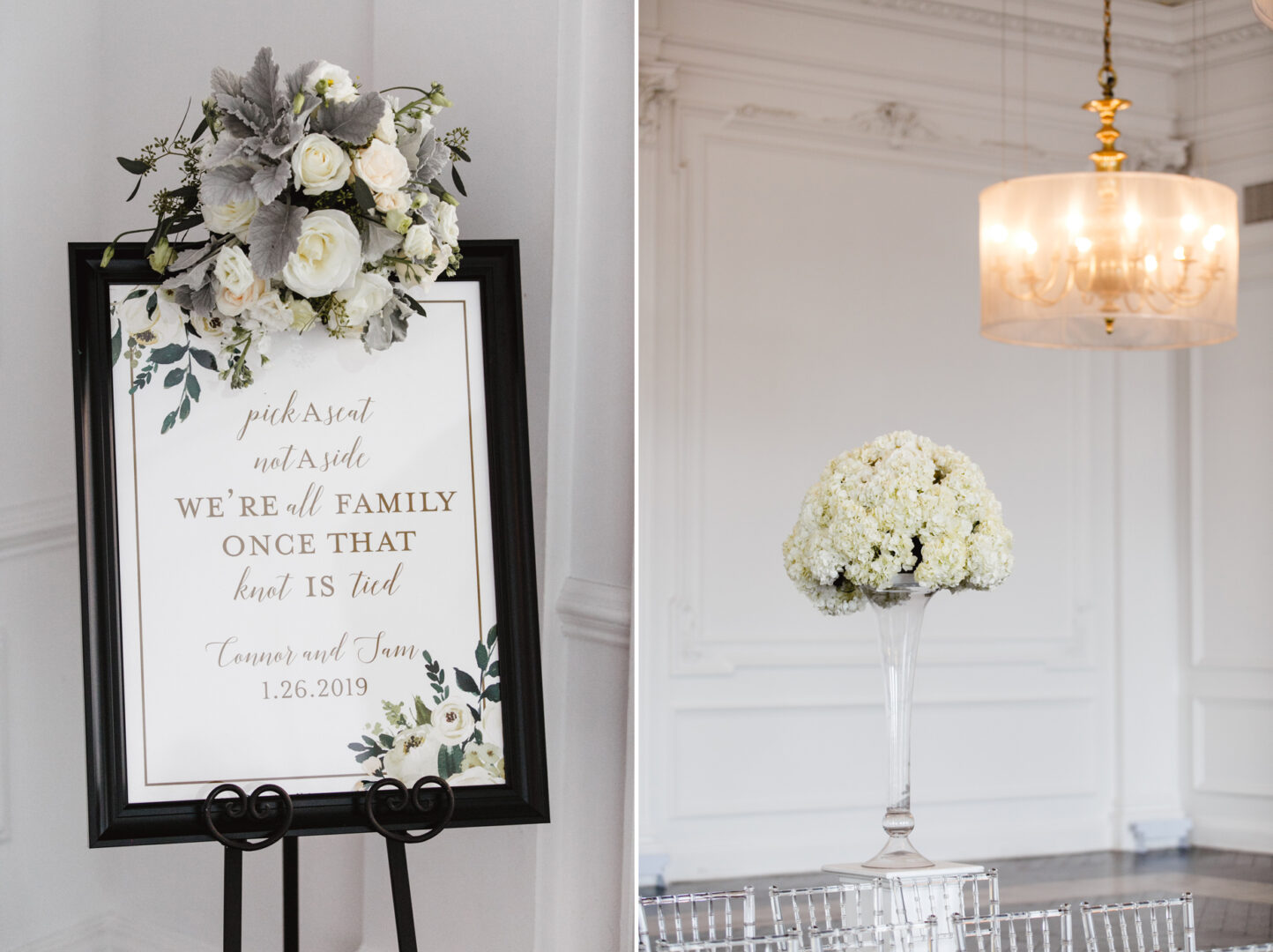 A wedding sign with white flowers reads, "Pick a seat, not a side. We're all family once the knot is tied. January 26, 2019." Next to it at the Downtown Club Wedding, stands a tall floral arrangement with white blooms.