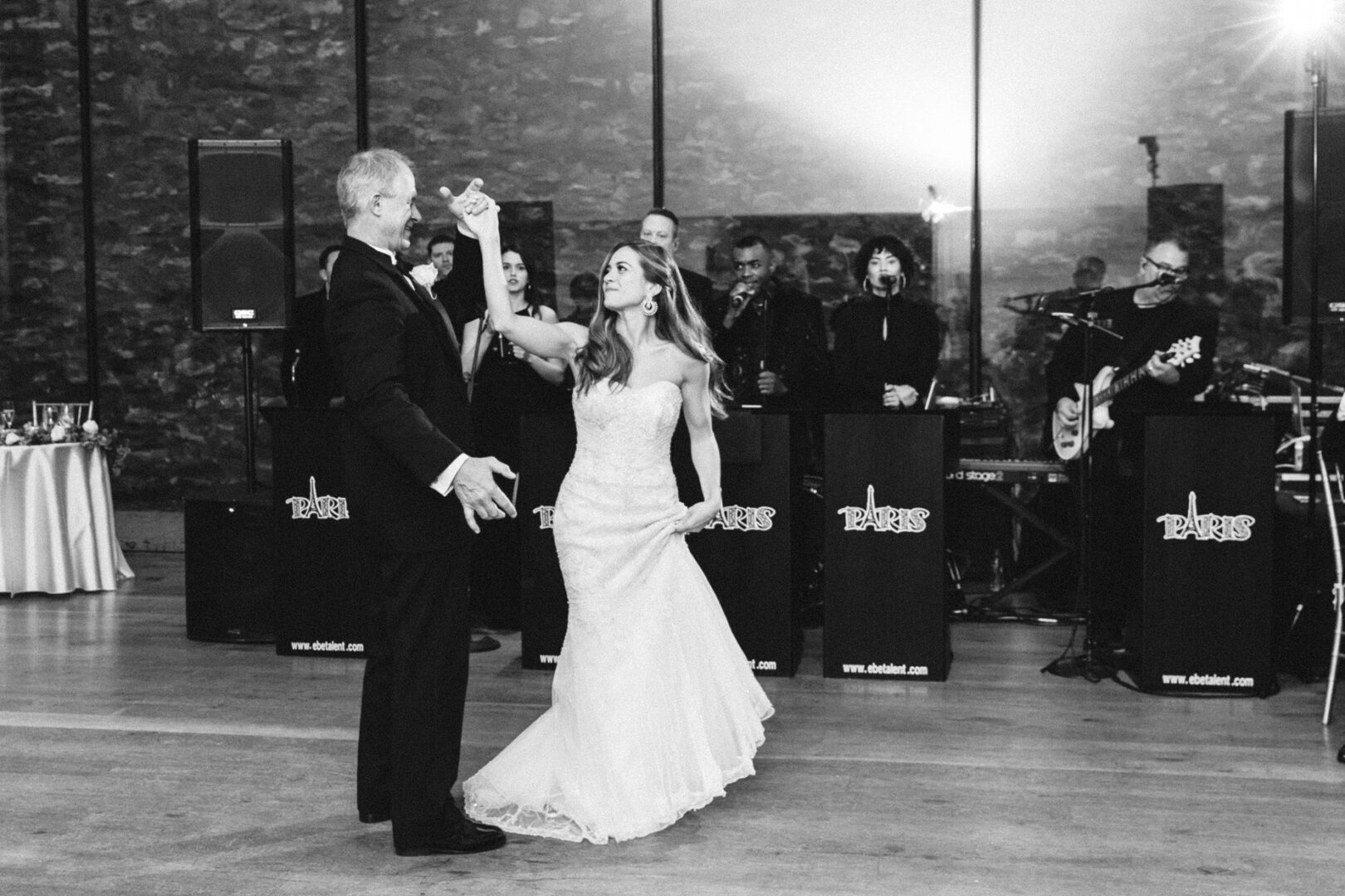 Bride and groom dancing at a Michener Art Museum wedding, with a band playing in the background.