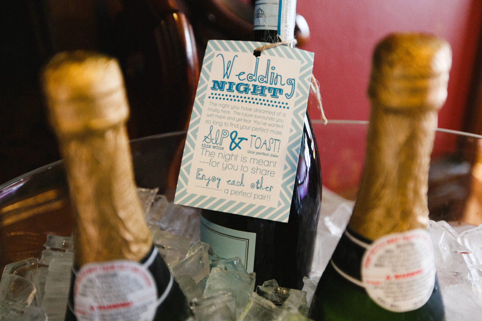 Wine bottles in an ice bucket with a decorative card labeled "Wedding Night" attached to one bottle, perfect for a Knowlton Mansion Wedding.