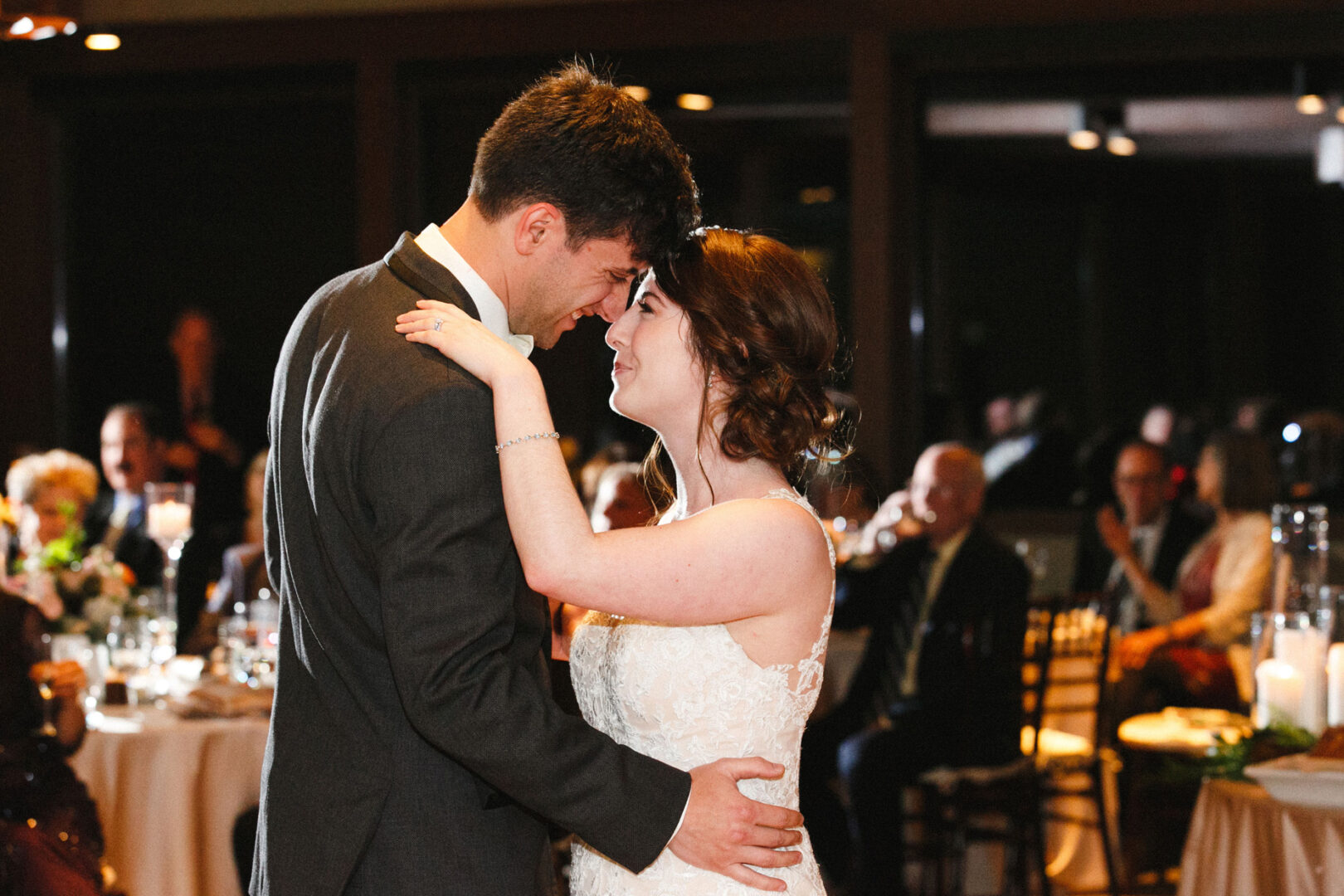 At the Union League at Liberty Hill, a bride and groom share their first dance at a charming wedding reception, surrounded by seated guests.