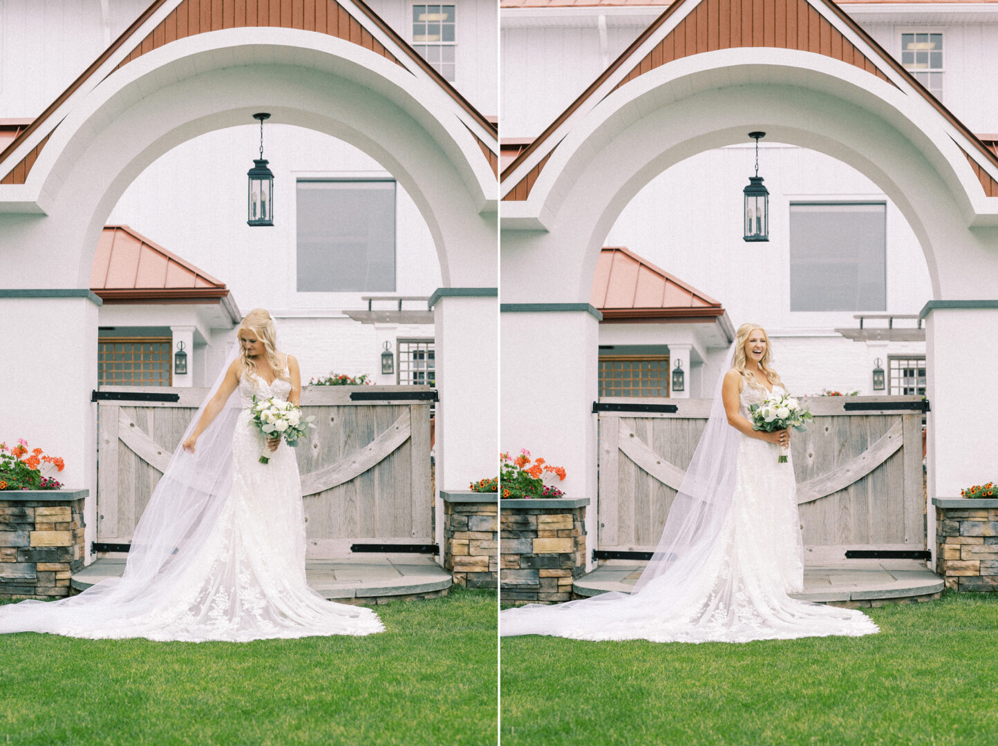 A bride in a white lace gown and long veil stands gracefully on the grass at her Normandy Farm wedding, holding a bouquet with a rustic archway and charming white building in the background.