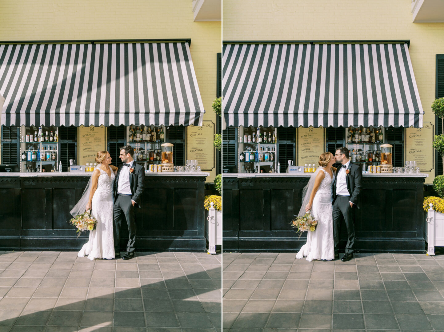 A couple in wedding attire kisses in front of a black outdoor bar with a striped awning and floral decorations, capturing the charm of a Cape May wedding.