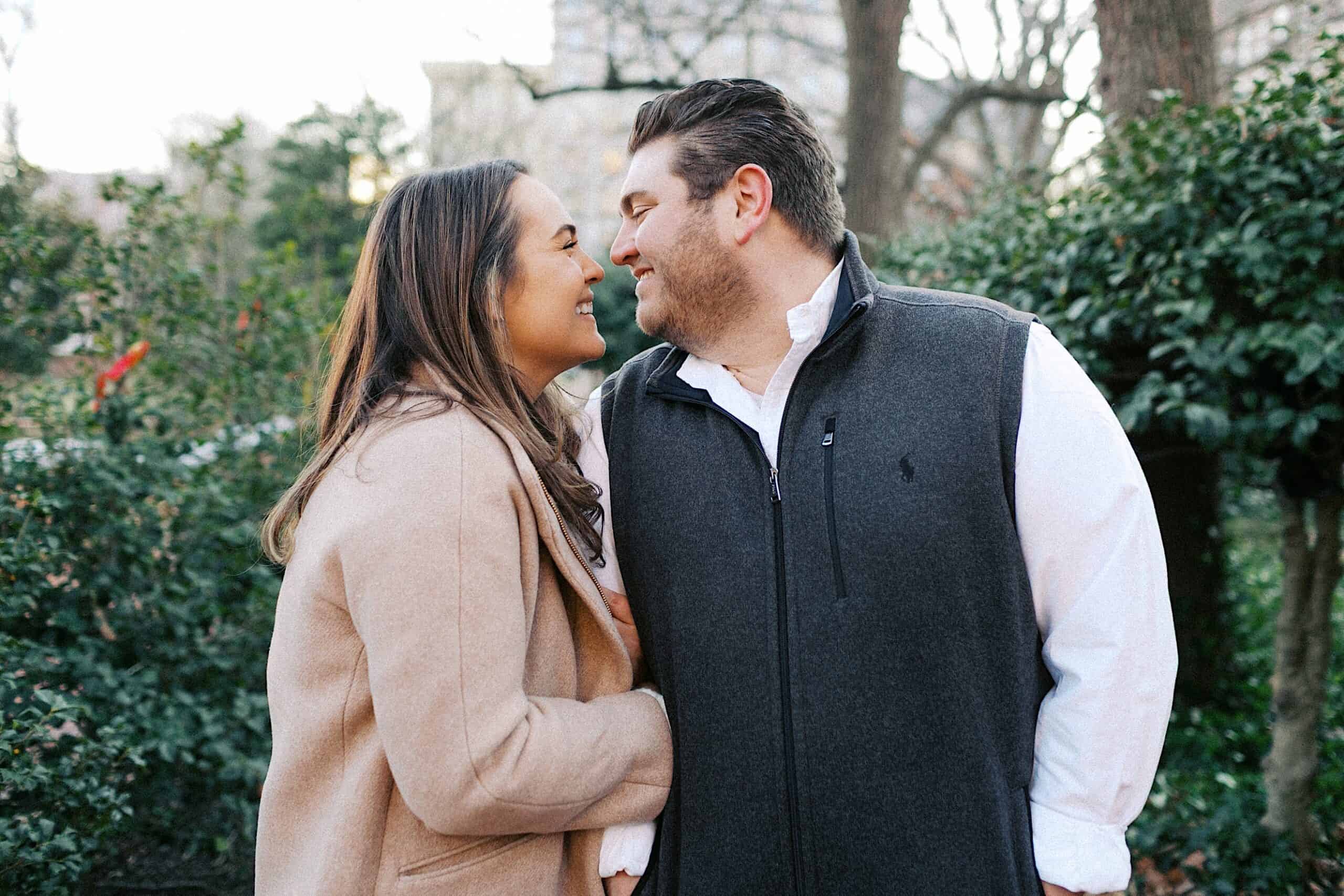 A man and woman smiling and touching noses.