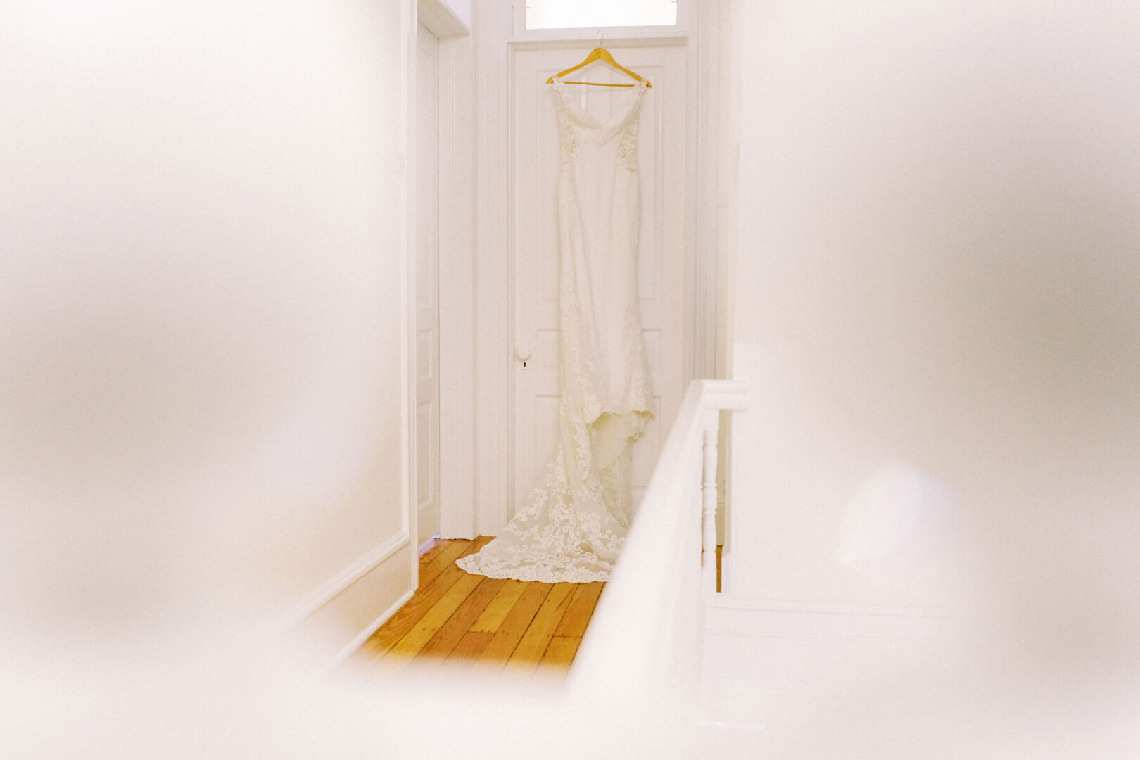 A La Soie wedding dress hanging on a door in Cape May.