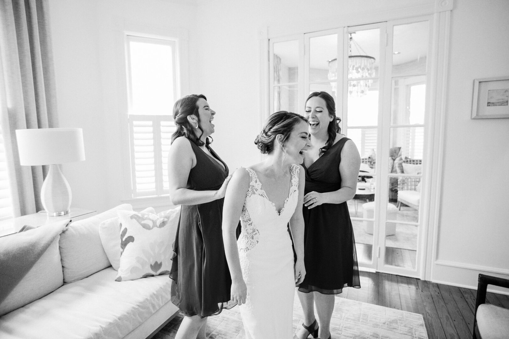 A bride laughs with her bridesmaids on her wedding day in Cape May.