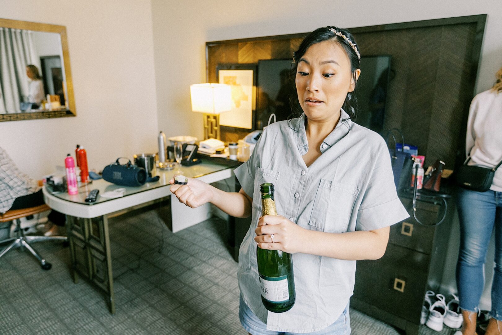 Bride uncorking champagne before her metropolitan wedding in Philadelphia