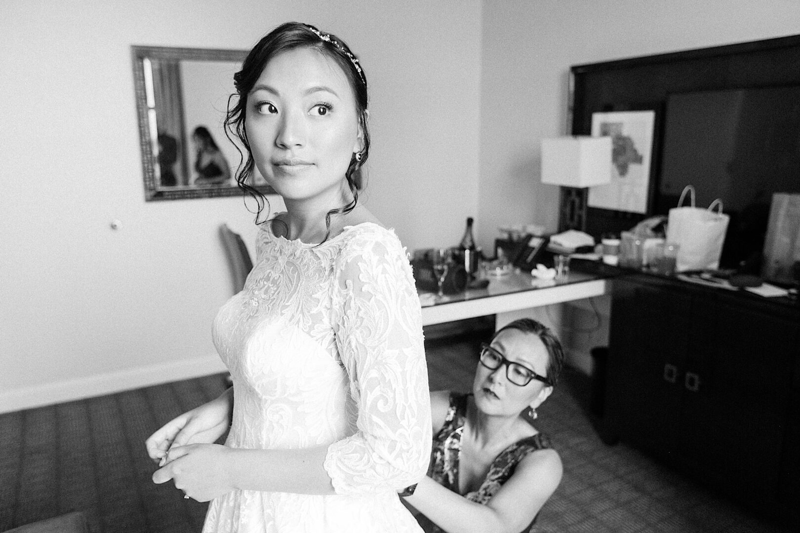 Mom helping Bride with wedding dress on her classic Philadelphia wedding day