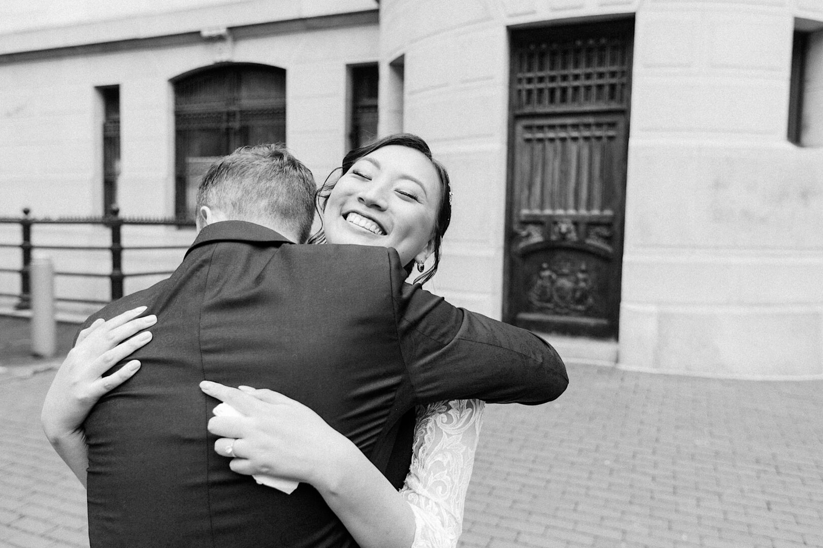 Bride and Groom hugging at their first look on their metropolitan Philadelphia wedding day