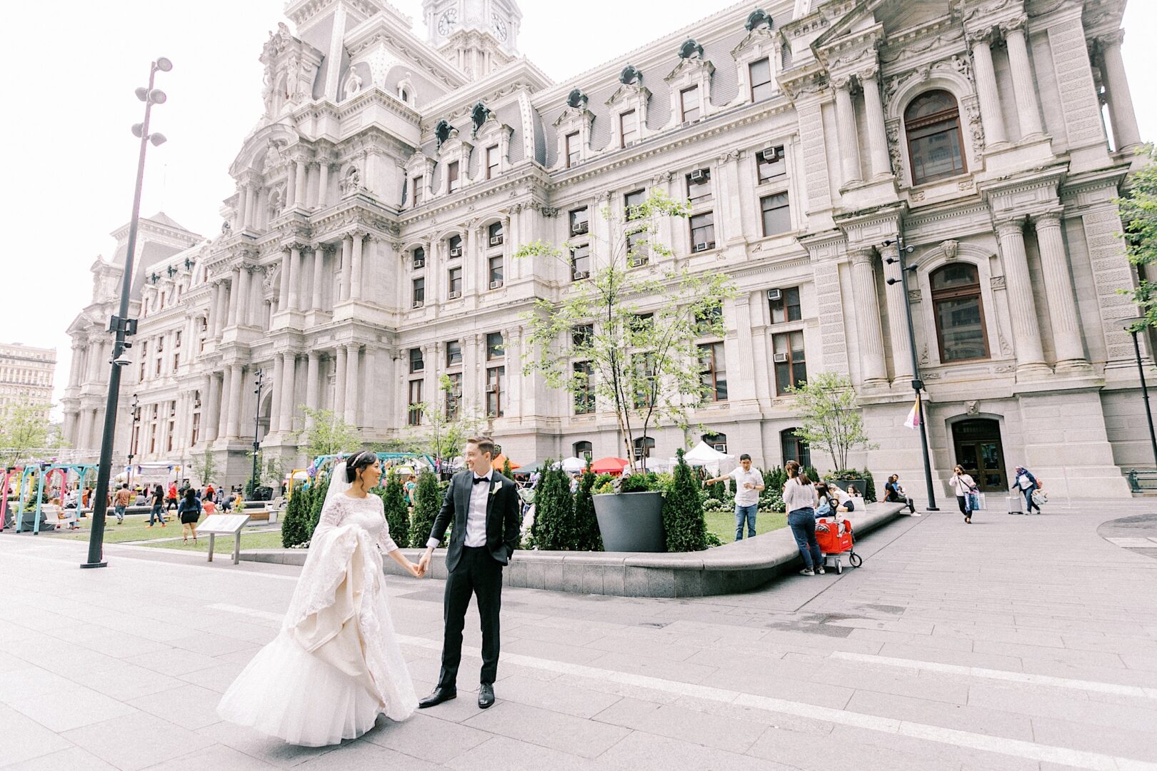 Bride and Groom holding hands at City Hall on their metropolitan Philadelphia wedding day