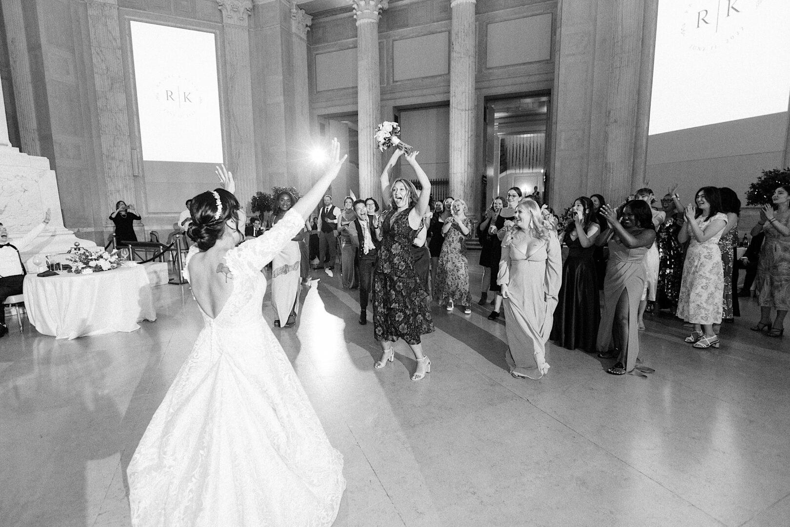 A wedding guest catching a bridal bouquet at a metropolitan wedding in Philadelphia