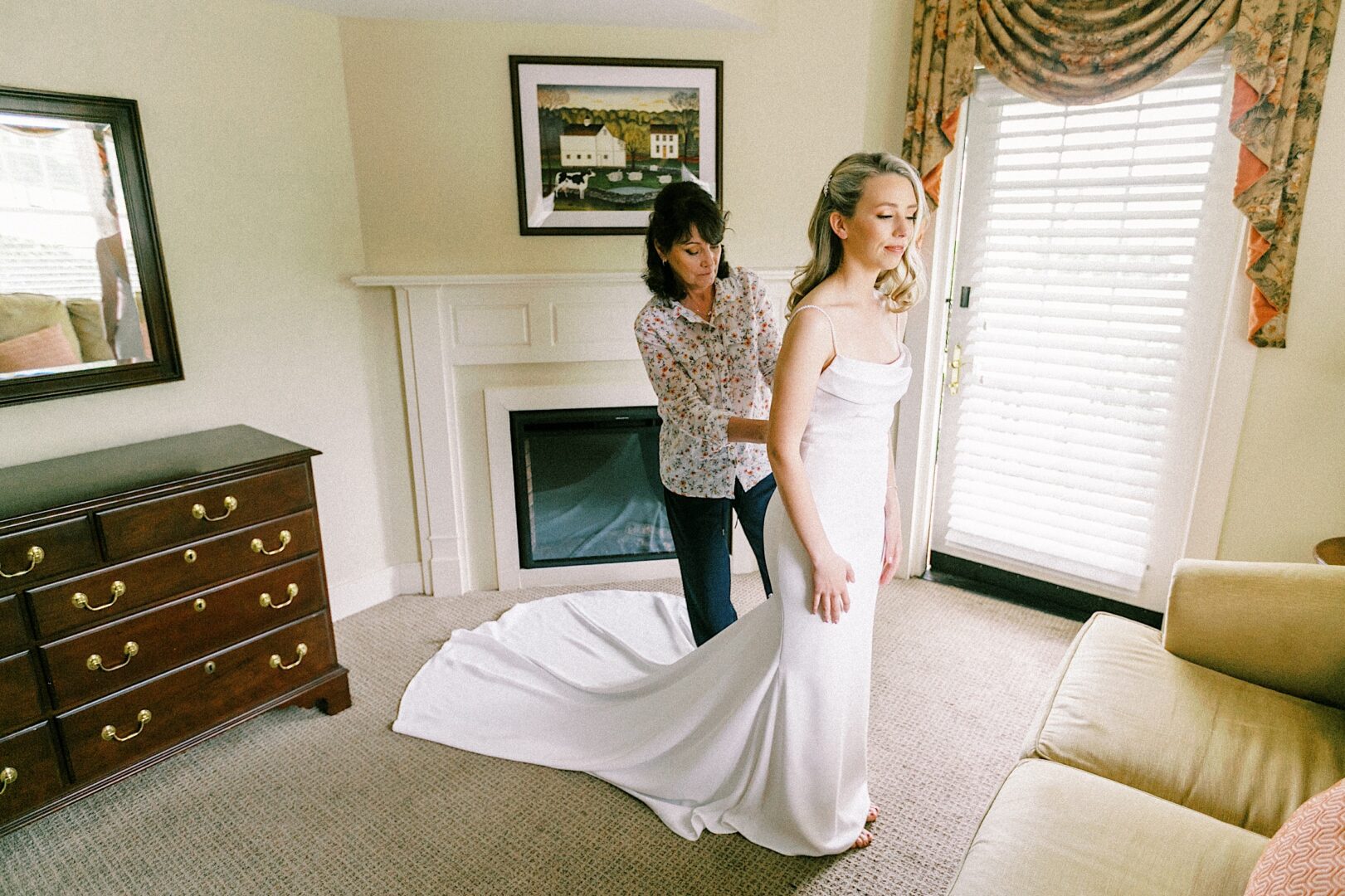 Mother of the bride helping the bride with her wedding gown by Philadelphia photographer Two17 Photo & Cinema