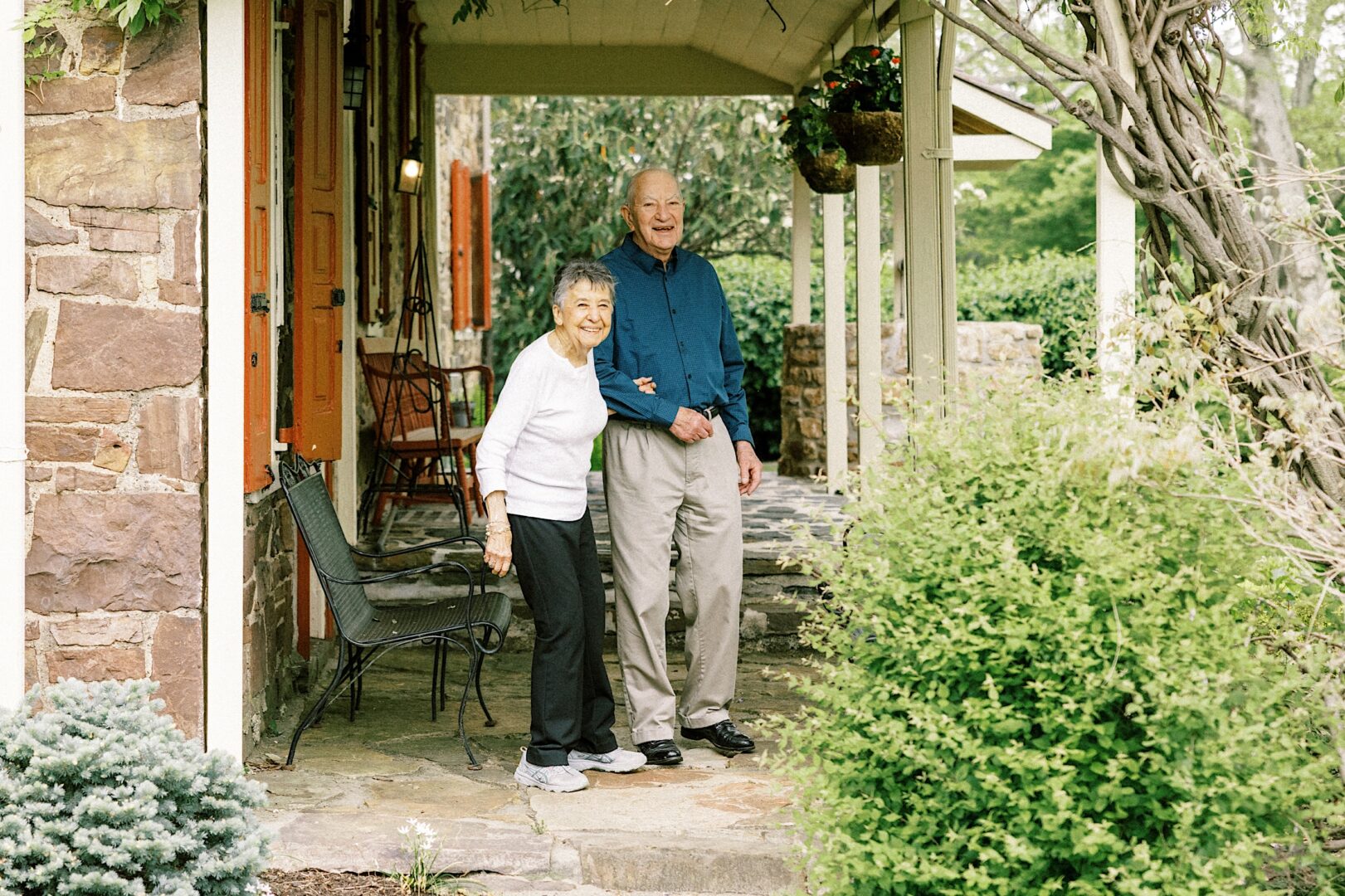 Grandparents smiling at the bride and groom on a bright spring day before a country club wedding