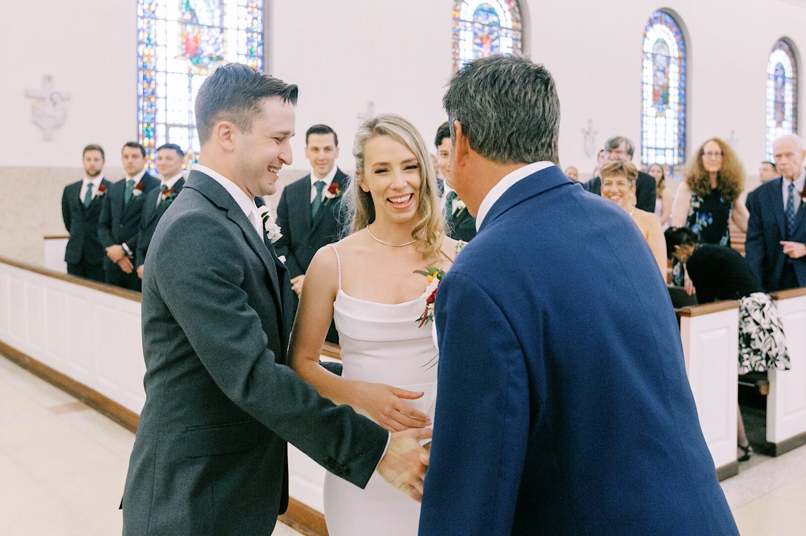 Father of the bride giving the bride away at a church wedding in Ambler