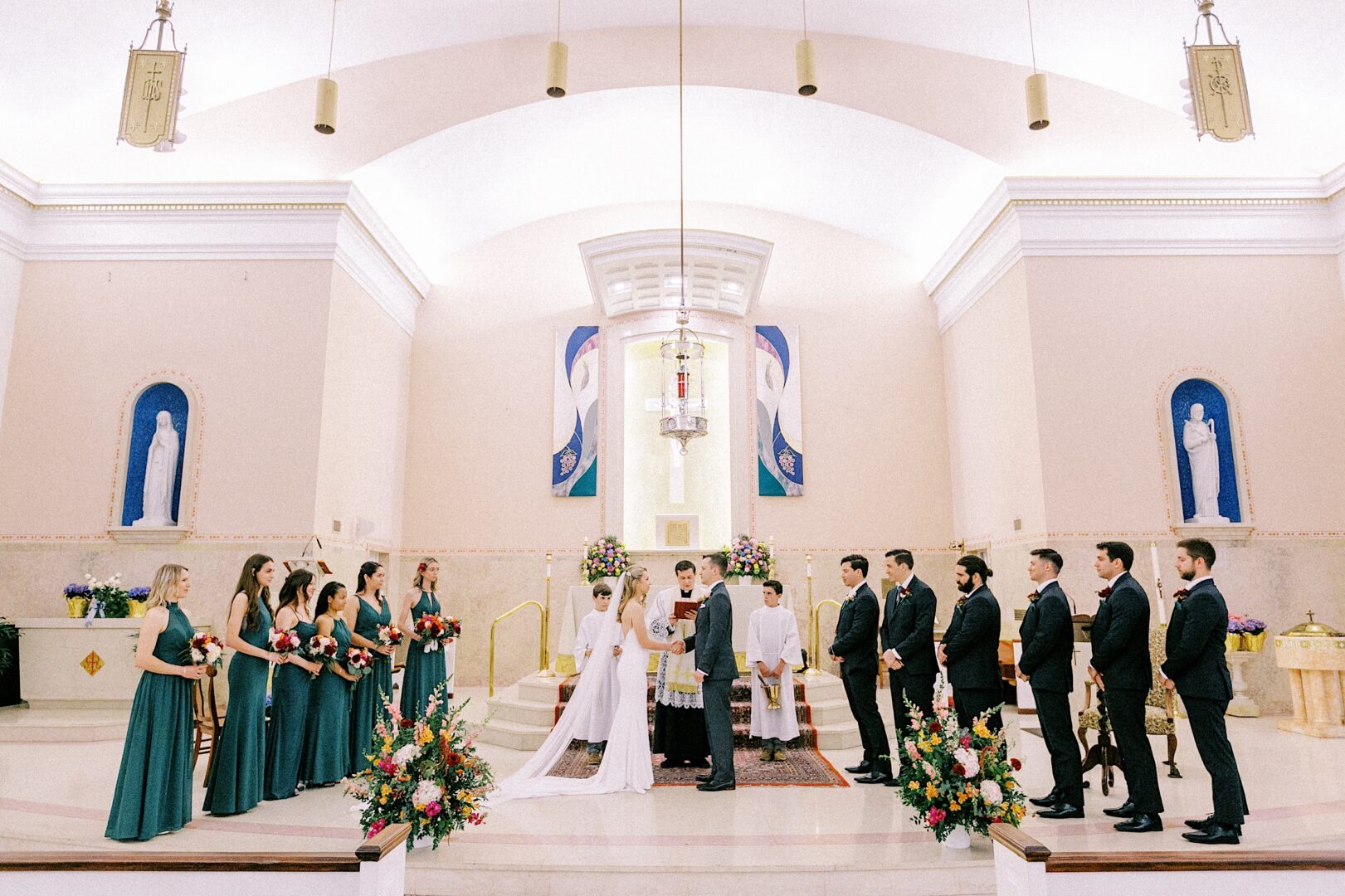 Bride and groom with the wedding party during a church ceremony on a spring day