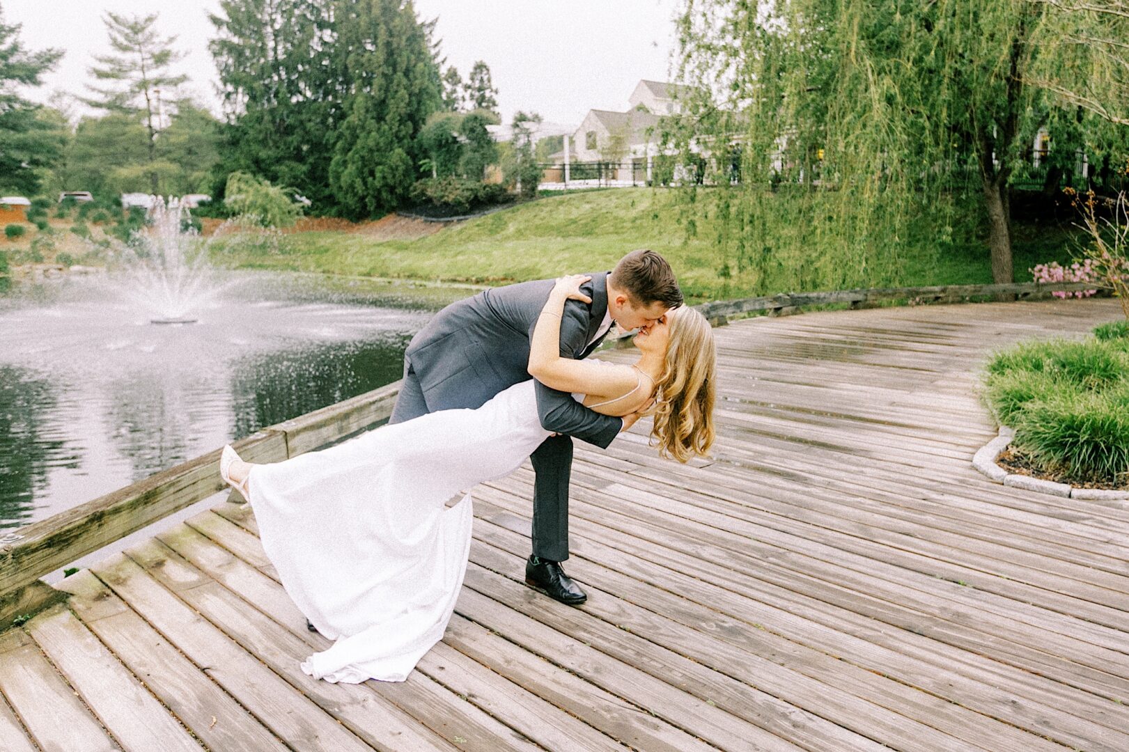 Groom dips bride on a colorful spring wedding day at Talamore Country Club