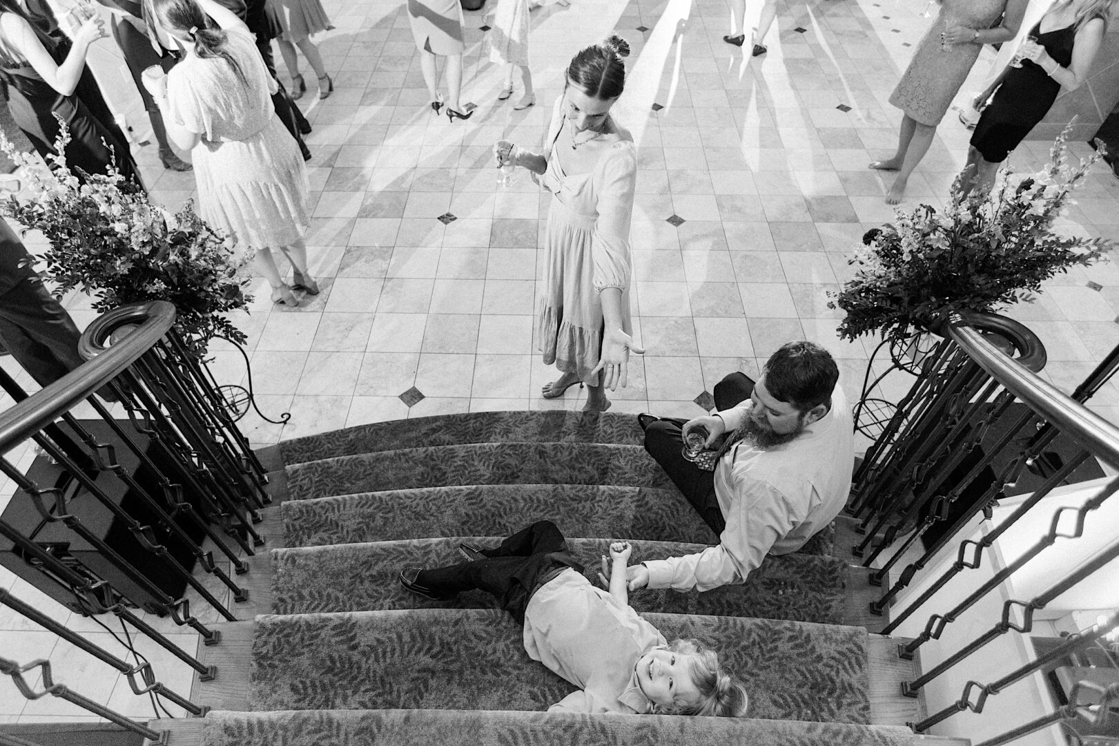 Kid resting on stairs after dancing at a energetic wedding reception by Philadelphia photographer Two17 Photo & Cinema