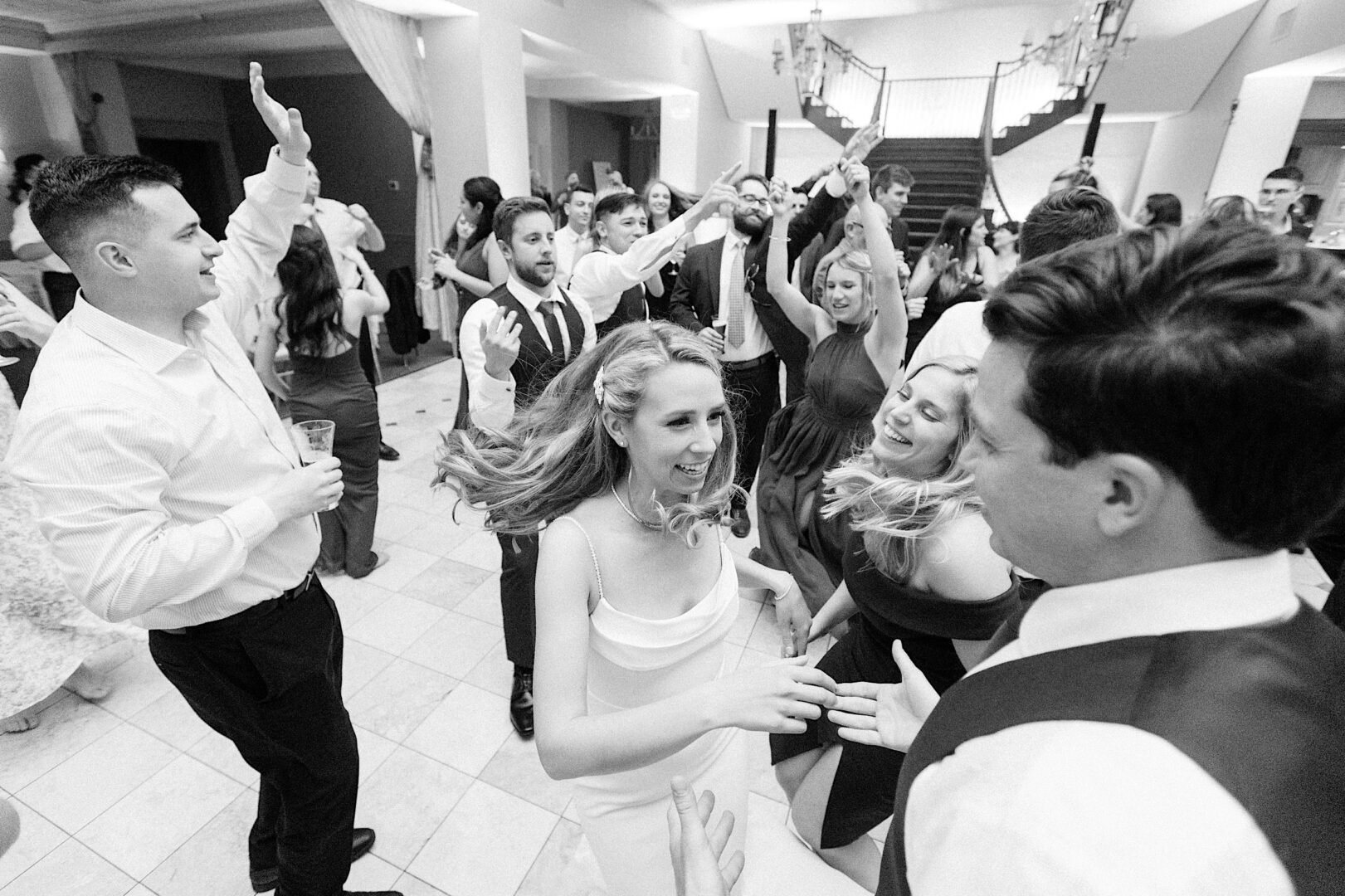 Wedding guests living it up on an energetic dance floor at a country club wedding by Philadelphia photographer Two17 Photo & Cinema