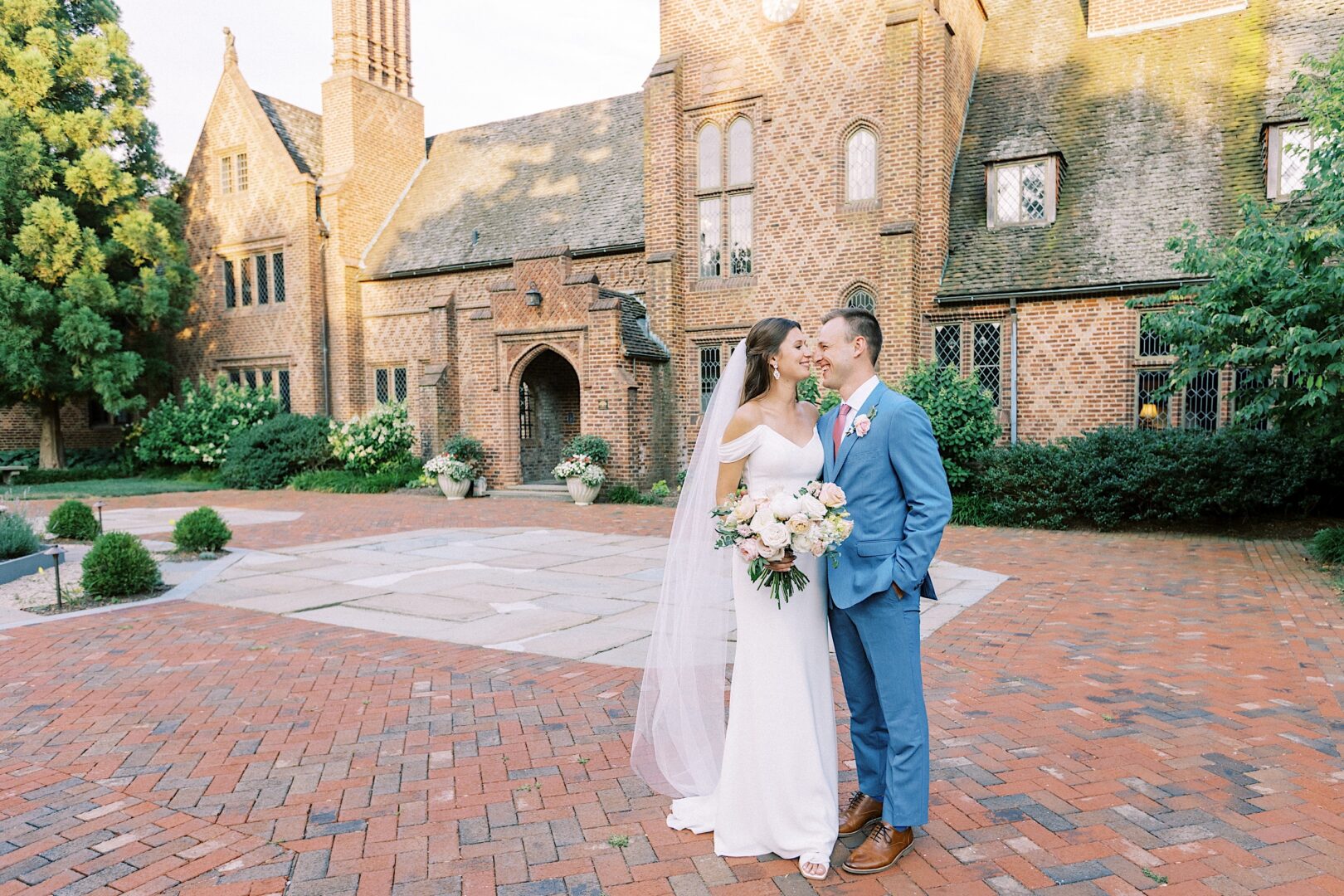 Bride and groom smiling at each other at a garden wedding at Aldie Mansion