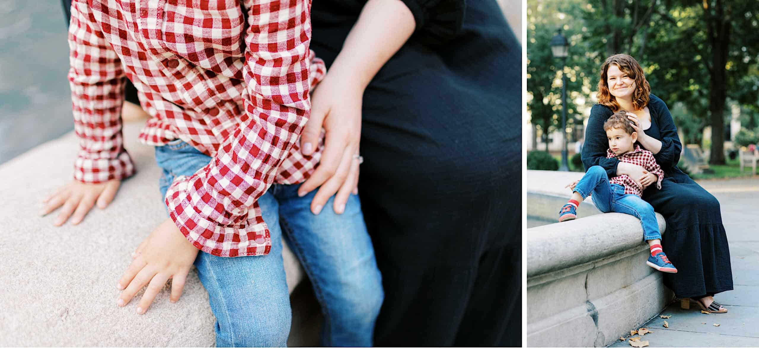 A woman in a black dress sits on a stone ledge with a young boy in a red plaid shirt and jeans on her lap, capturing family photos at Washington Square in Philadelphia.