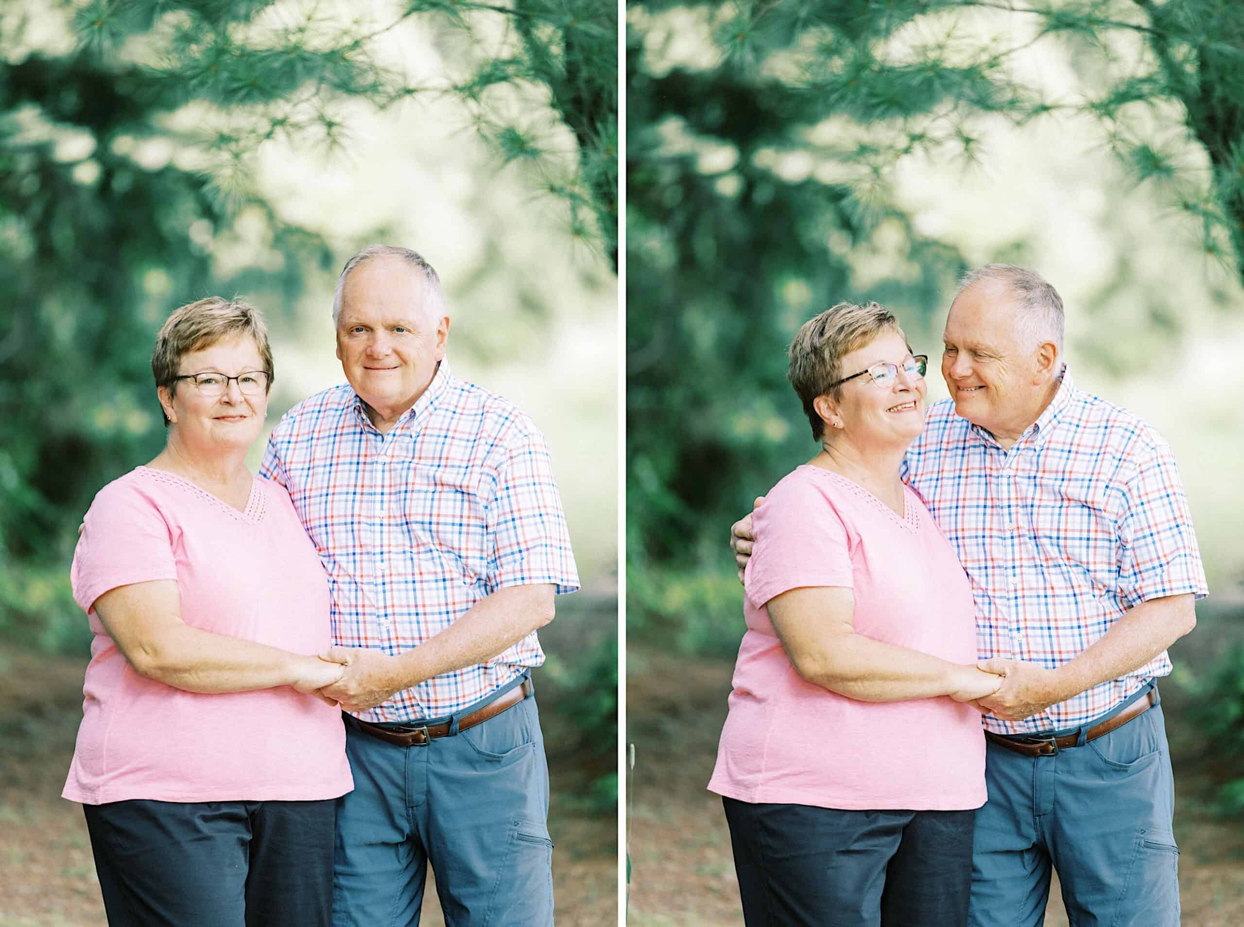 An older couple stands outdoors, holding hands and smiling at each other in casual clothes, surrounded by trees—the perfect setting for maternity or extended family photos.