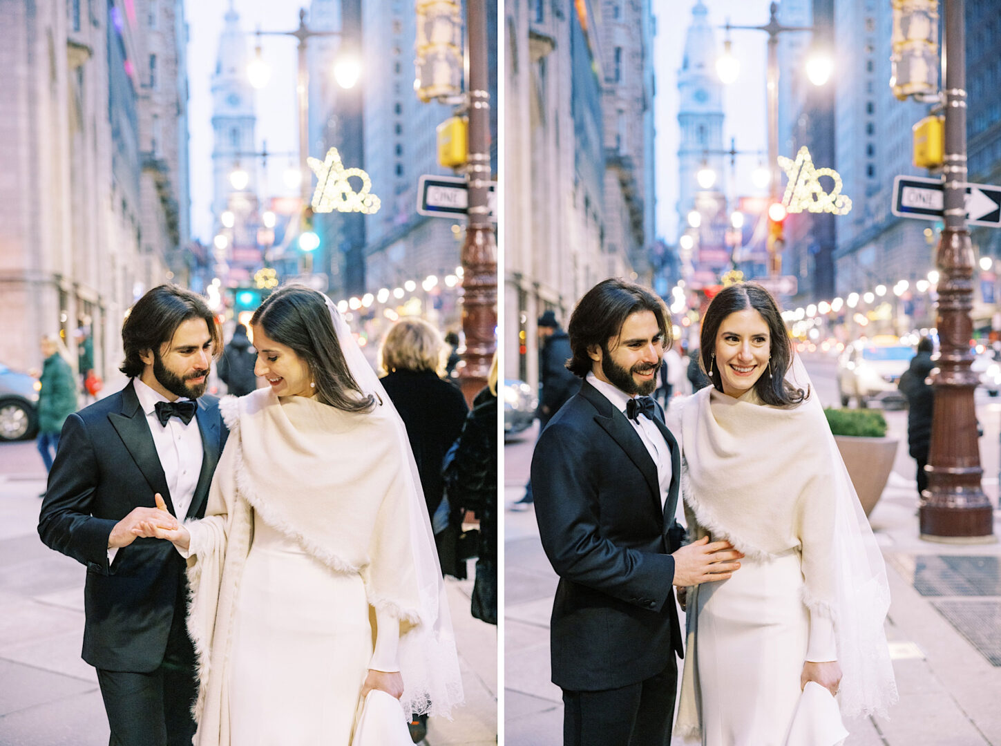 A couple dressed in formal attire walk and pose on a city street with the historic Kimmel Center in the background. The man wears a suit, and the woman, possibly adorned for their wedding or a New Year's Eve celebration, wears a white dress with a shawl.