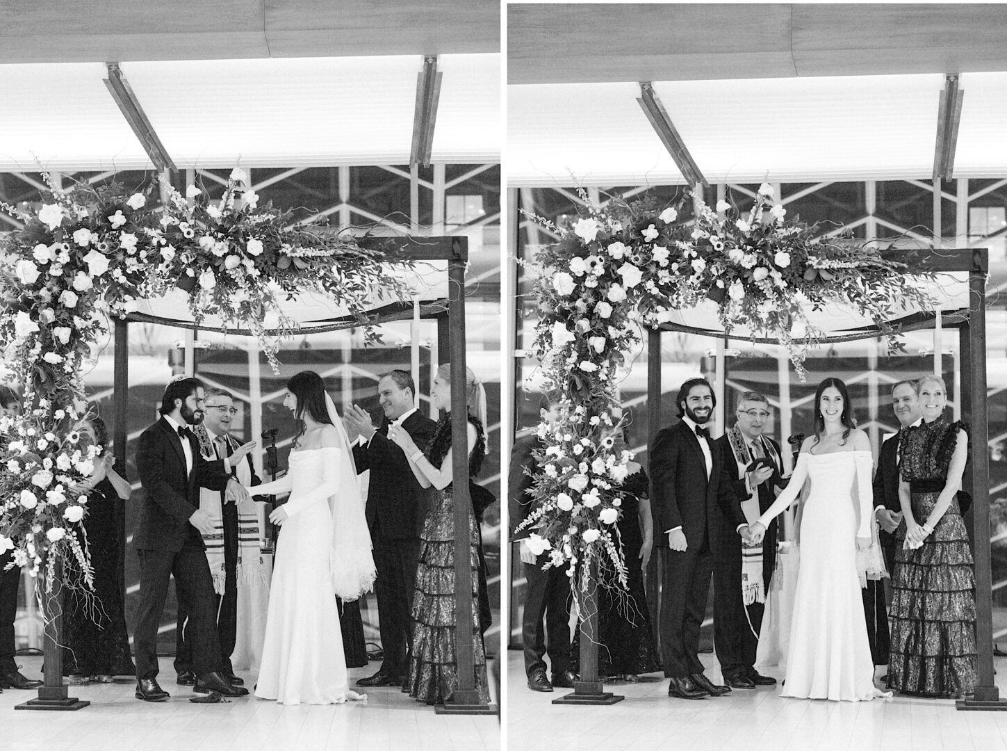 A black-and-white image of a wedding under a floral arch at the Kimmel Center in Philadelphia. The couple stands with their officiant and two other individuals, likely parents. They are all smiling and holding hands, capturing the joy of a New Year's Eve celebration.