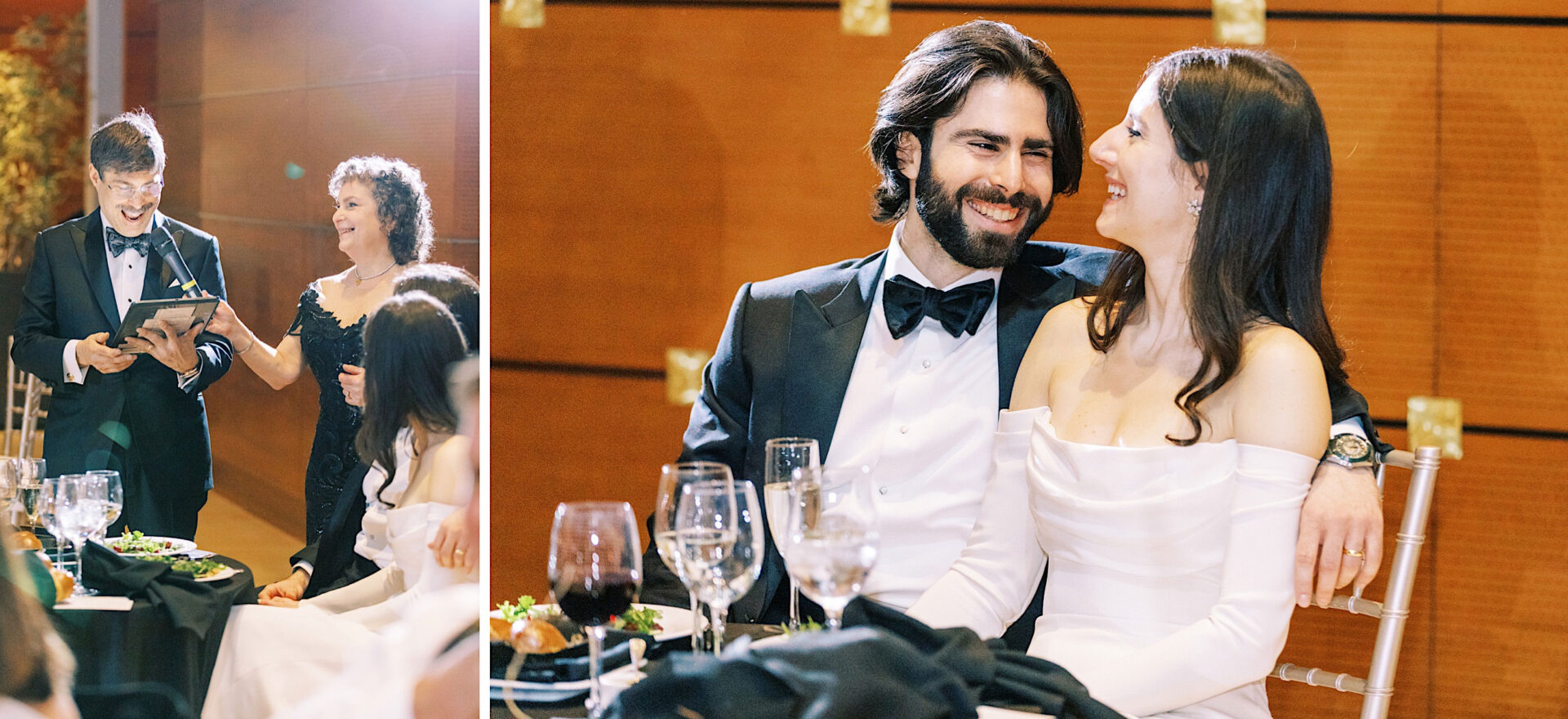 A couple in formal attire sits, smiling and laughing at their wedding, while a man and woman standing nearby hold a microphone and speak against the elegant backdrop of the Kimmel Center in Philadelphia.