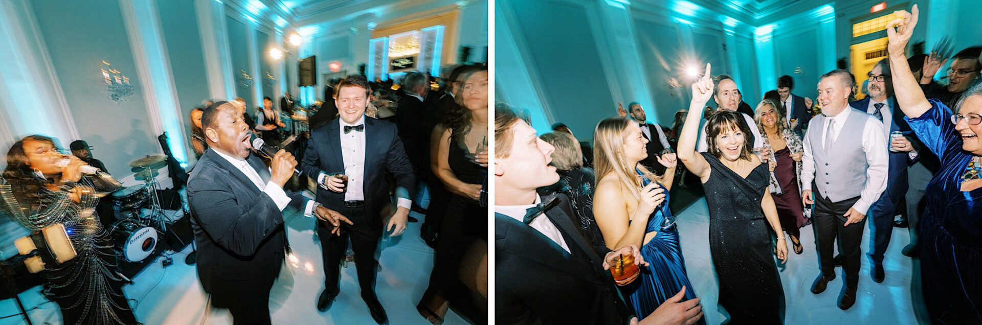 People dancing and singing at a formal event in the Ballroom at Ellis Preserve Wedding, enjoying the lively atmosphere in a well-lit room with a live band.