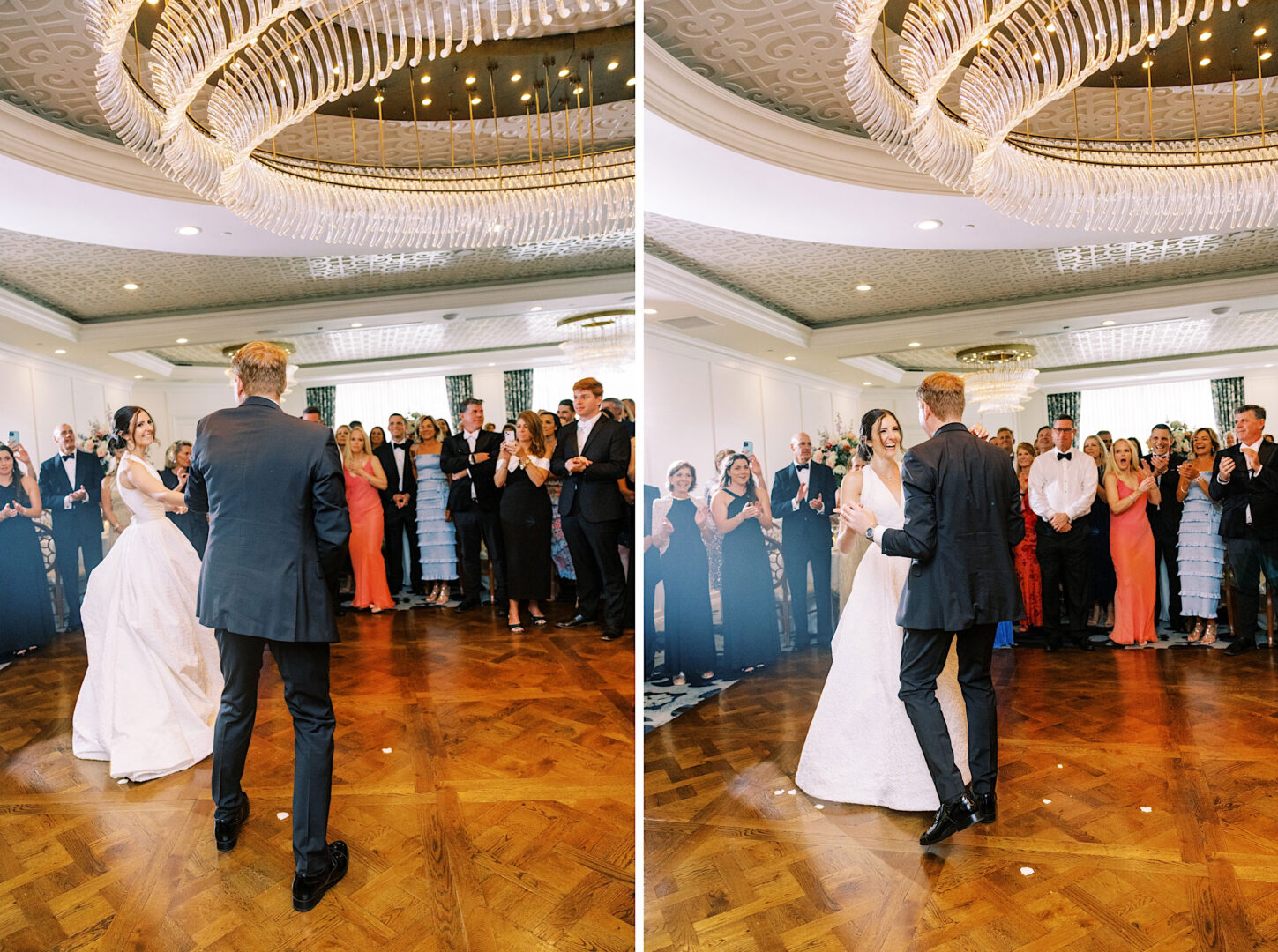 A couple dances together under a chandelier in a ballroom at the Overbrook Golf Club Wedding, surrounded by guests from Philadelphia who are watching and clapping.