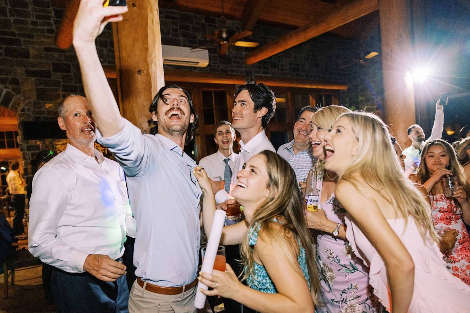 A group of people smiling and taking a selfie at an indoor event at The Ridge at Back Brook. They appear to be enjoying themselves in the festive atmosphere of this beautiful country club in New Jersey.