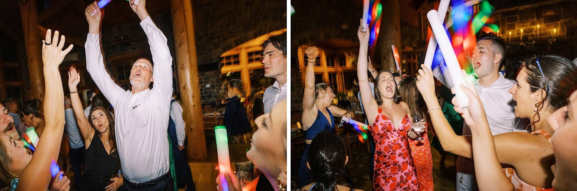 People dancing energetically at a wedding party, holding colorful light sticks in a dimly lit room at The Ridge at Back Brook.