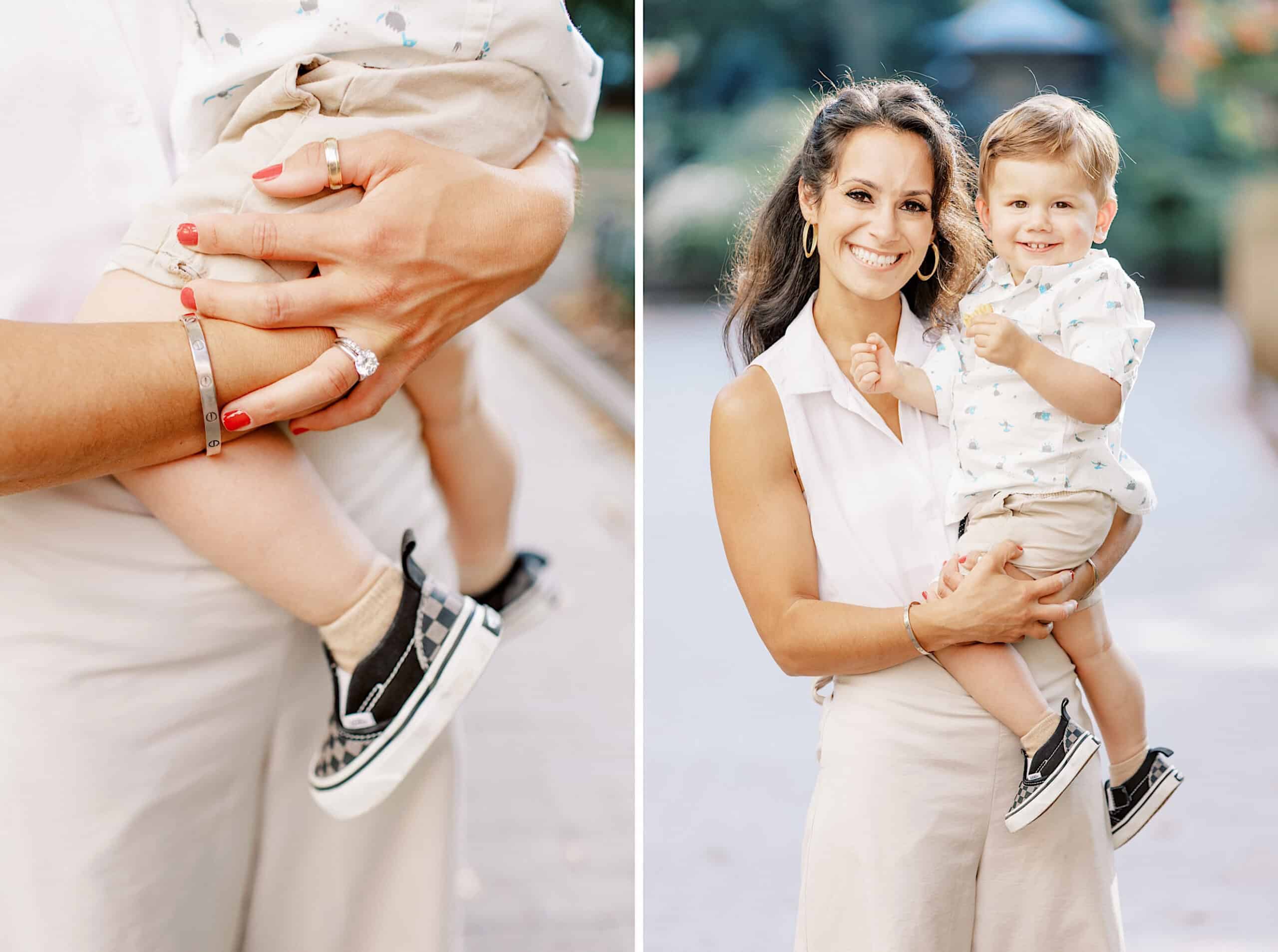 A woman holds a smiling toddler in her arms outdoors during family photos at Rittenhouse Square; close-up of her hand and the child’s legs is shown on the left.