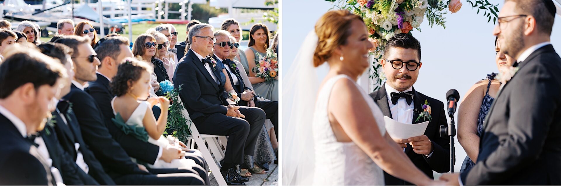 At the Corinthian Yacht Club of Cape May, a wedding ceremony unfolds gracefully with guests seated on the left. The couple stands facing each other, exchanging vows with the officiant on the right, surrounded by elegant floral decorations that add charm to this memorable occasion.