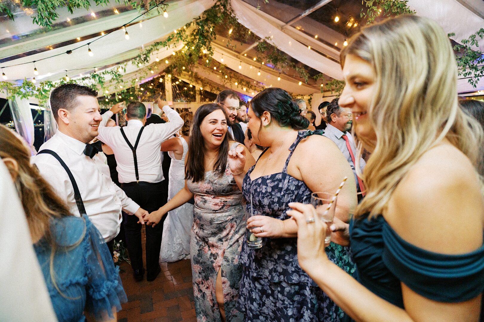 Under a canopy with string lights, guests danced and socialized, celebrating a beautiful Corinthian Yacht Club of Cape May wedding.