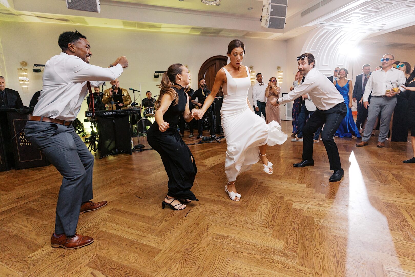 At The Tilling House wedding, guests watched as people danced energetically to the live band's rhythm, turning the formal event into an unforgettable celebration.