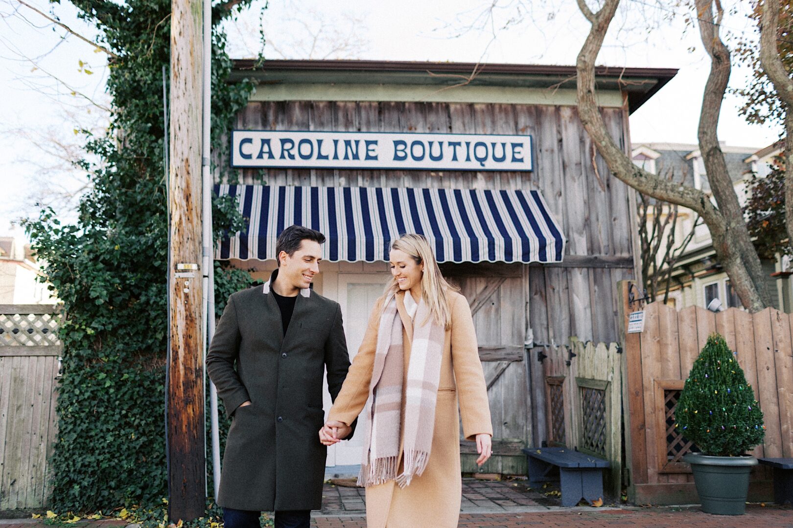 Cape May town engagement photos in front of Caroline Boutique during the off-season. 