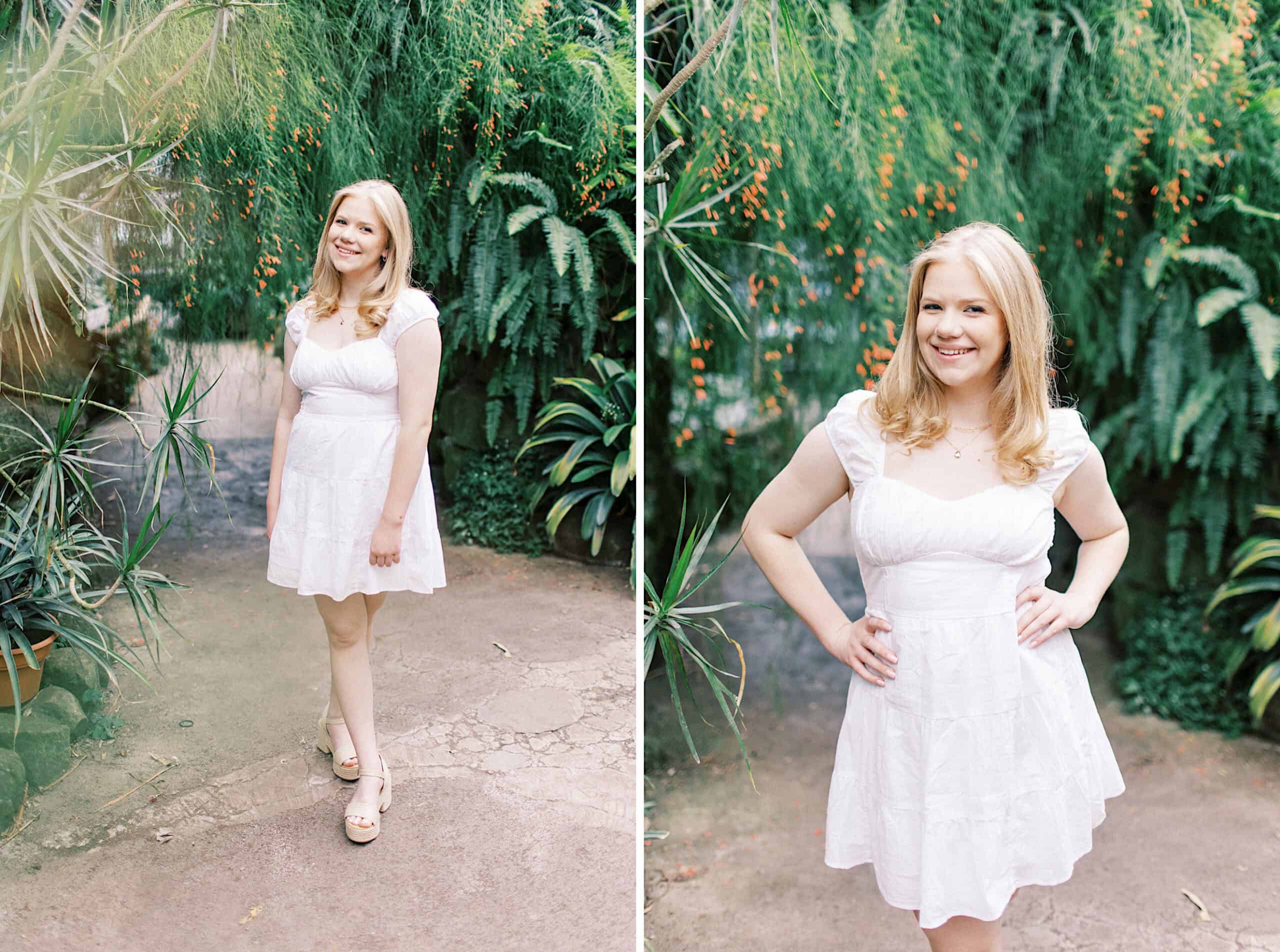 A woman with blonde hair wearing a short white dress stands outdoors, surrounded by green plants, smiling at the camera during her Senior Portrait Session in Montgomery County.