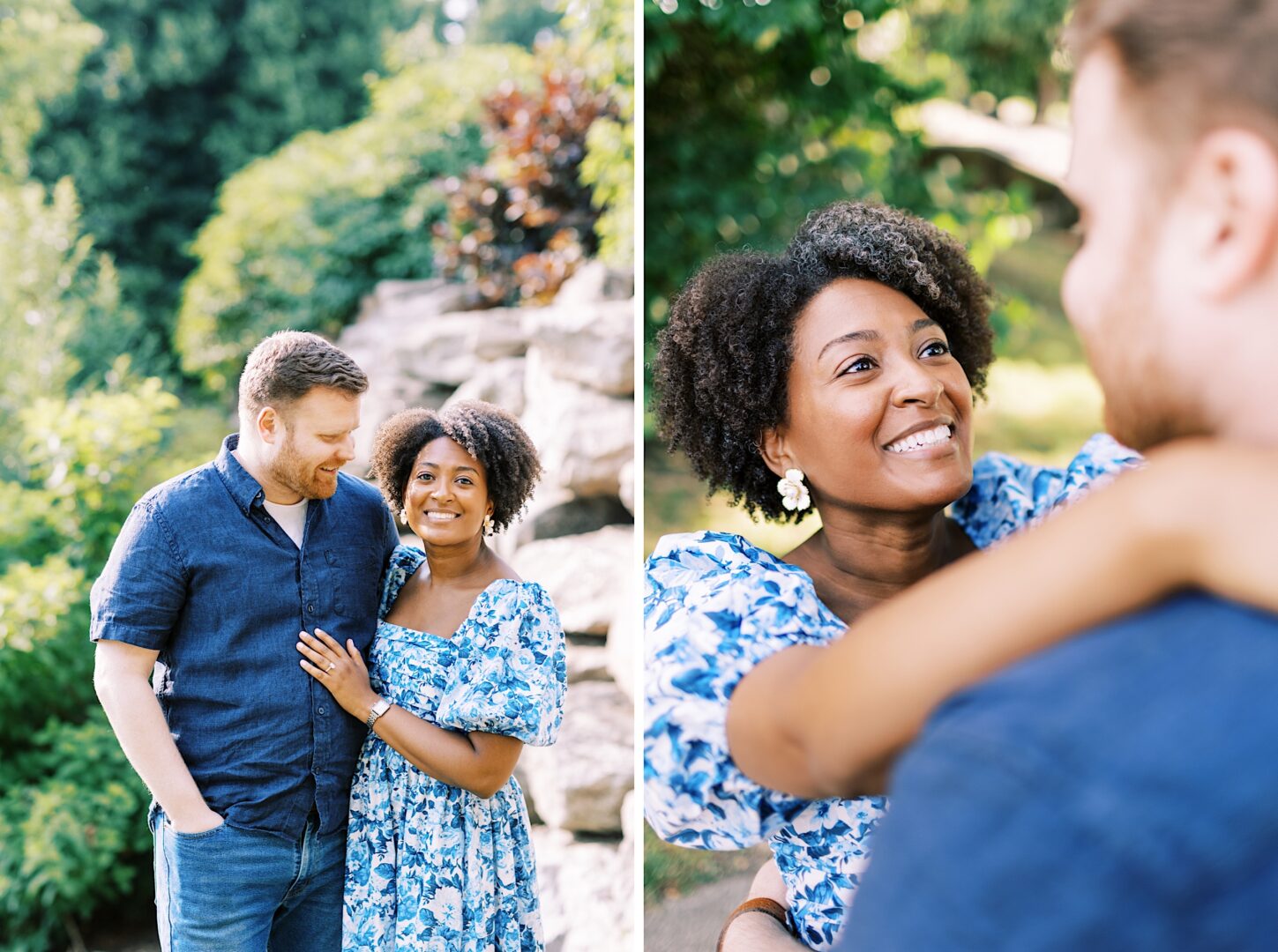 A couple stands together outdoors, smiling at each other. They are dressed in blue and surrounded by greenery and rocks.