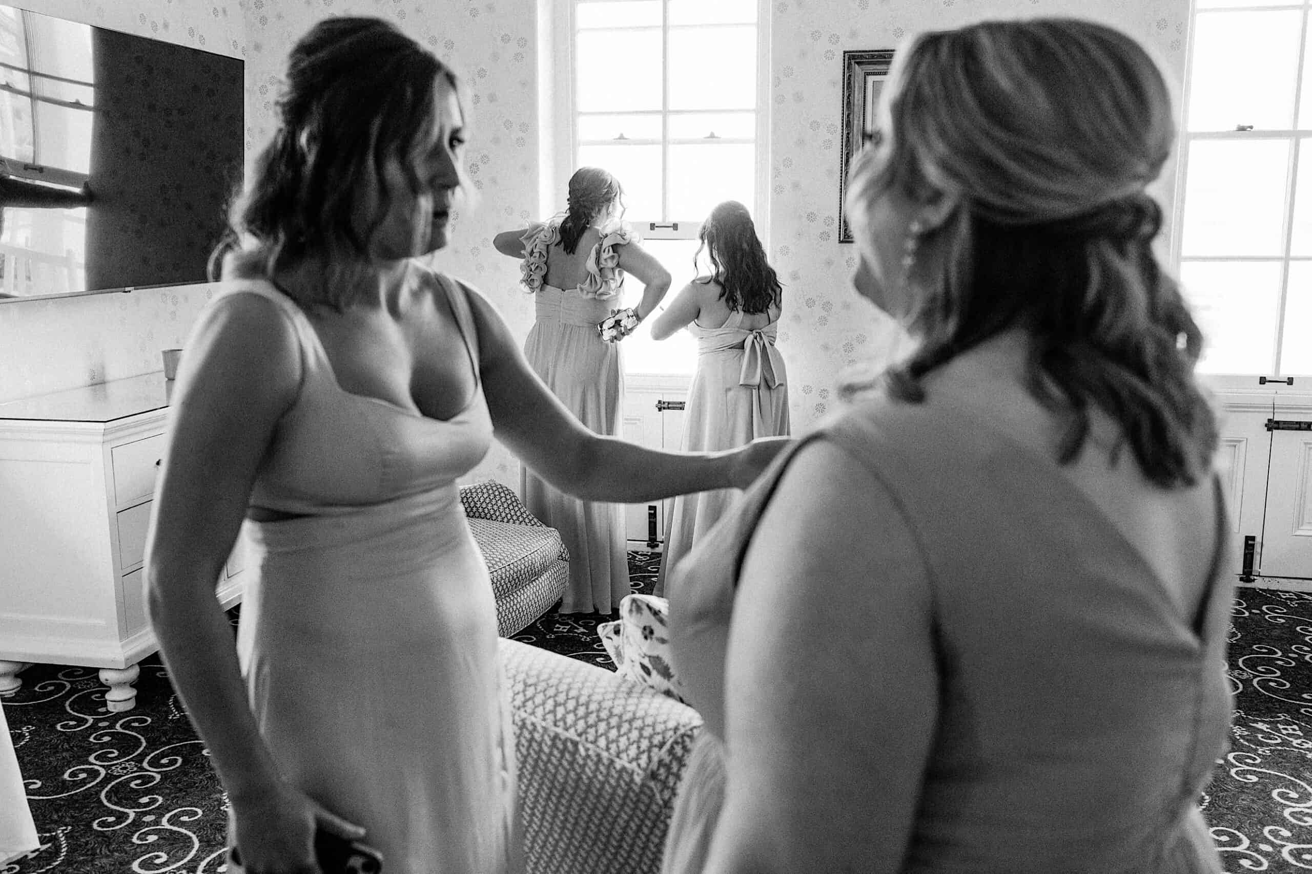 A group of women in dresses gathers, capturing the joy and elegance perfect for a New Jersey Beach Wedding Venue.