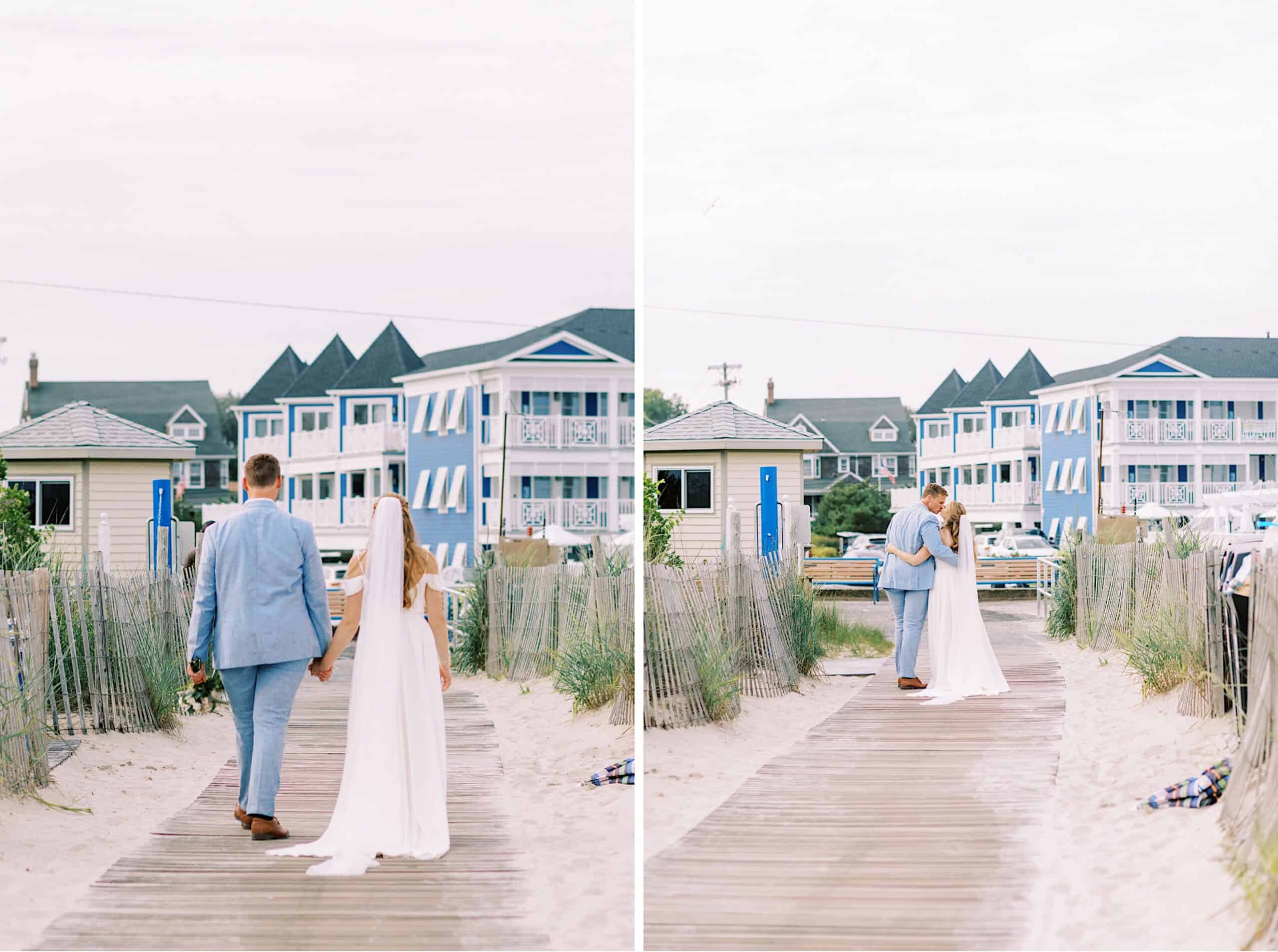 A bride and groom in light summer attire walk and embrace on a boardwalk leading to the beach at Montreal Beach Resort, with blue and white houses in the background.