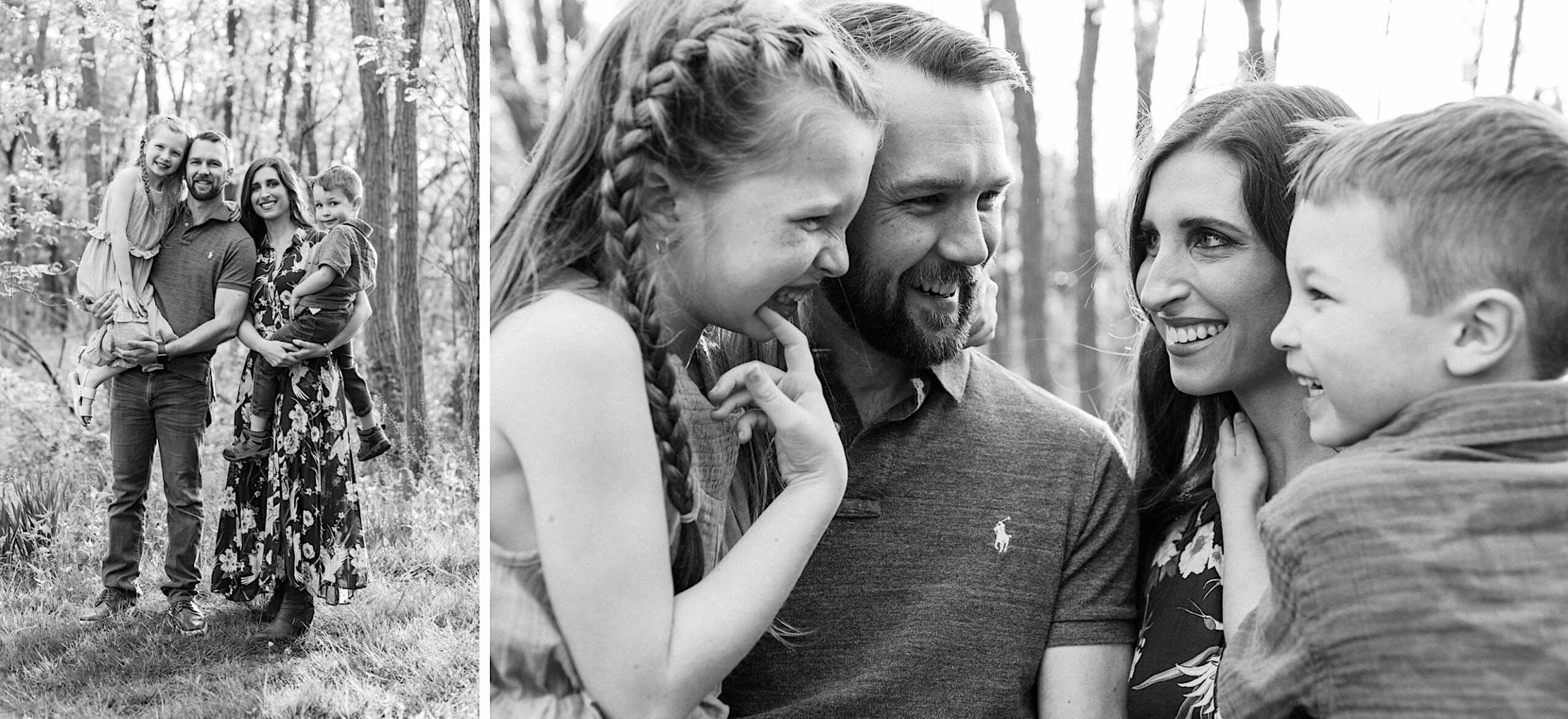 A family of four stands and smiles together outdoors in a wooded area, with two children interacting closely with their parents.