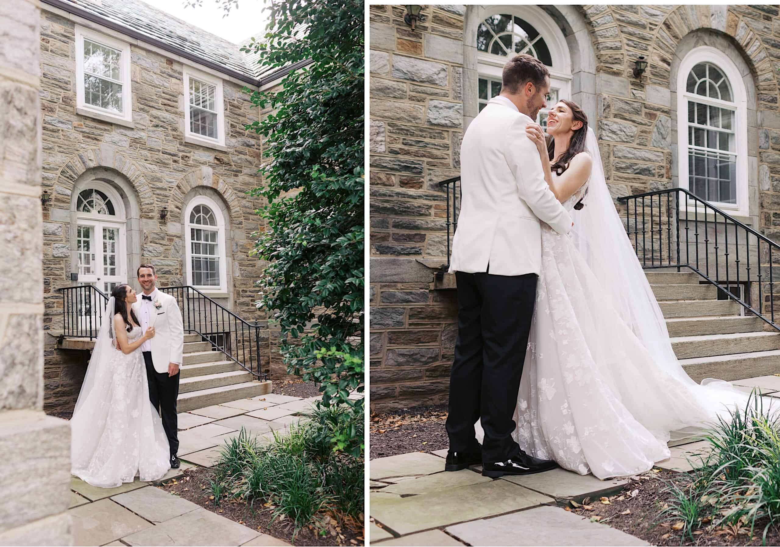 A bride and groom stand together outdoors, smiling and embracing near stone steps and a building with arched windows during their luxurious wedding at The Ivy at Ellis Preserve.