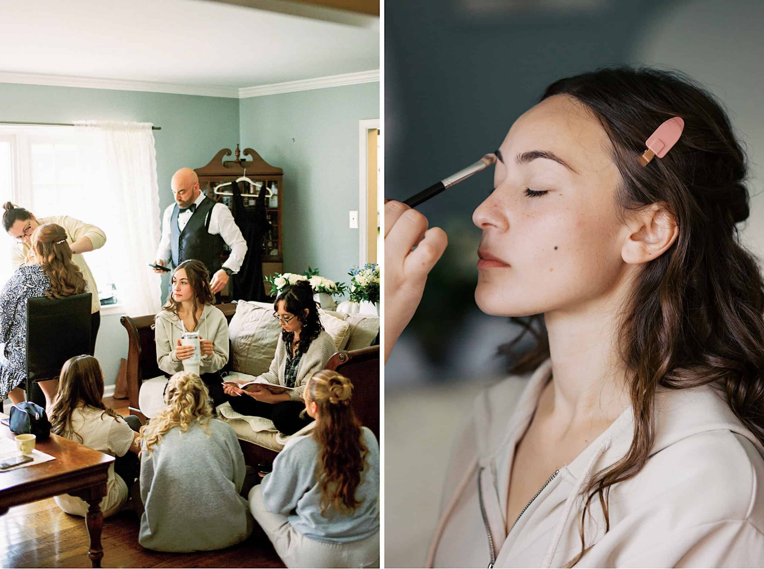 A group of people gathers in a living room at a beautiful Lochwood Manor wedding, some seated and some standing, while a woman has her makeup applied in a close-up shot on the right.