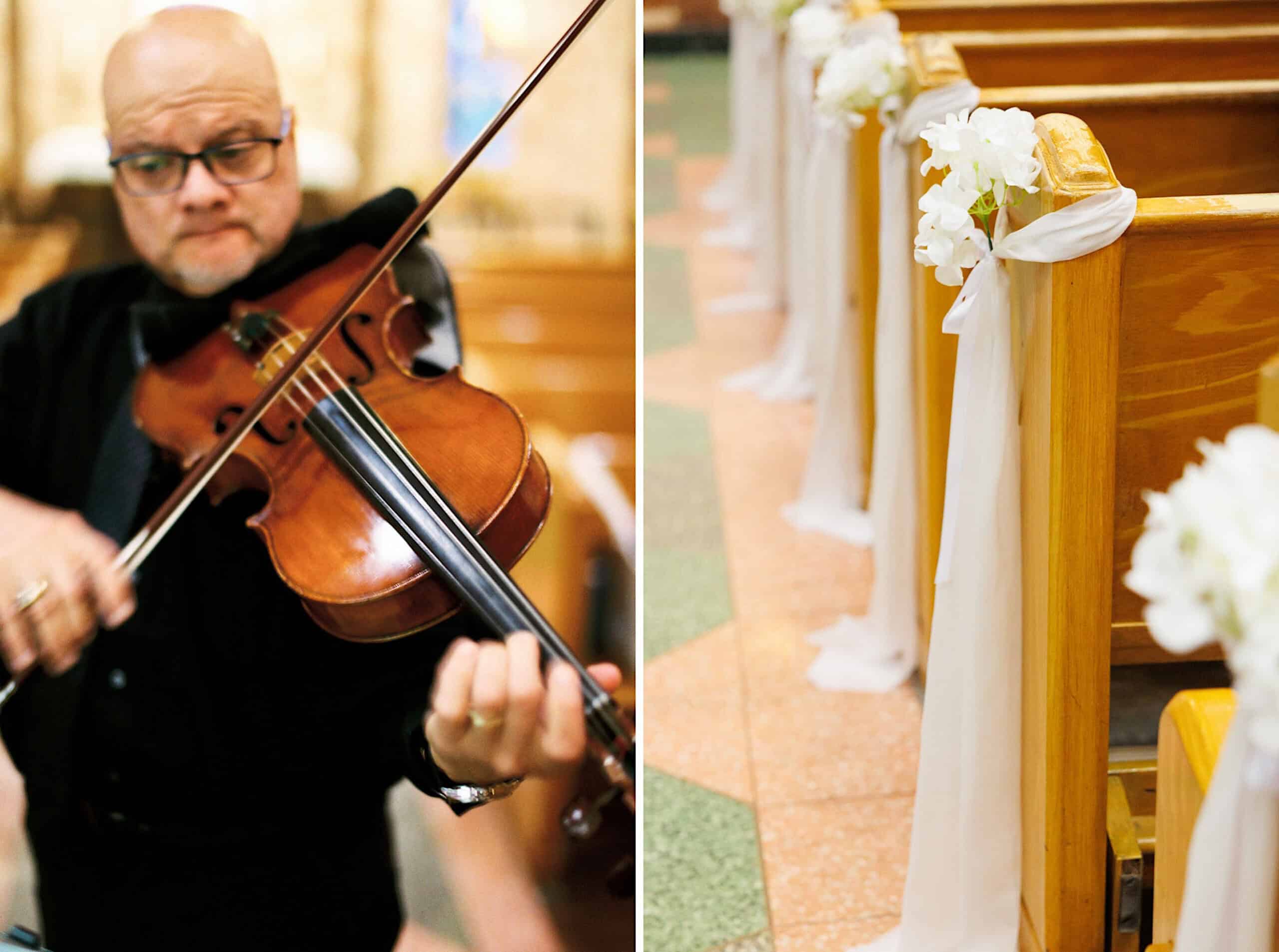 A man plays a violin in a church; next to him, wooden pews are decorated with white fabric and flowers at this beautiful Lochwood Manor wedding.