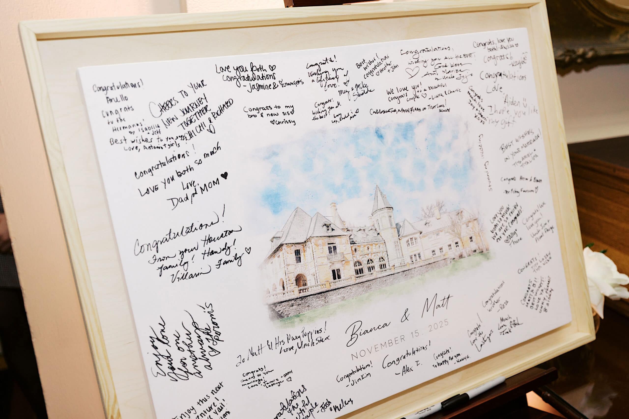 A framed wedding guest sign-in board features a sketch of Cairnwood Estate and handwritten congratulatory messages surrounding the names "Brenna & Matt" and the date November 15, 2025—perfect for an elegant Cairnwood Estate Wedding.